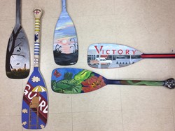 Five canoe Paddles painted by students with Bainbridge Theme.