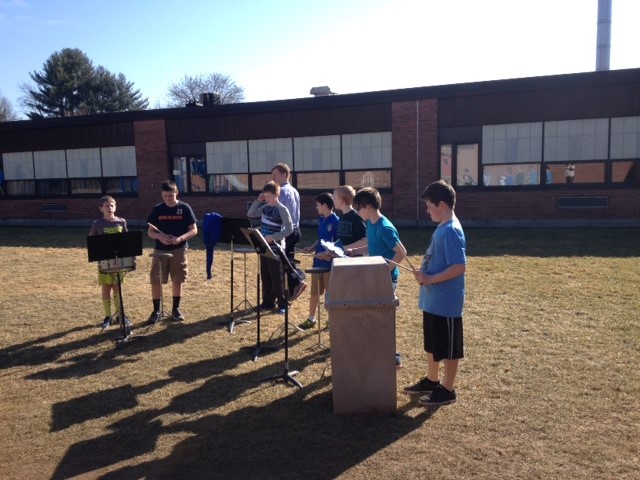 Mr. Jenkins and students making music in the sunshine.
