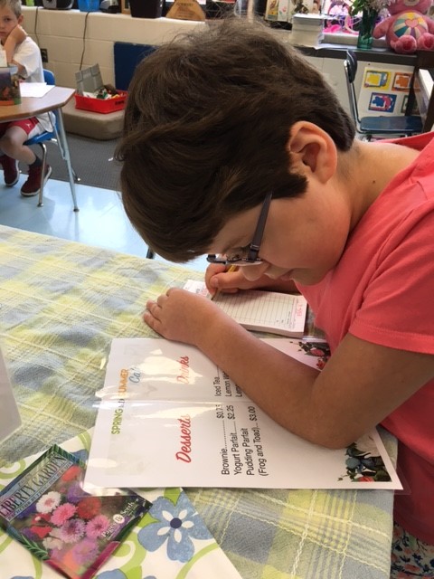 A Greenlawn Student peruses the Summer Cafe Menu.