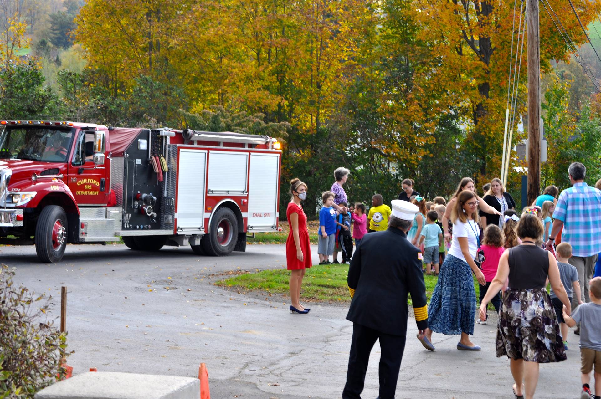 A fire truck arrives as students watch.