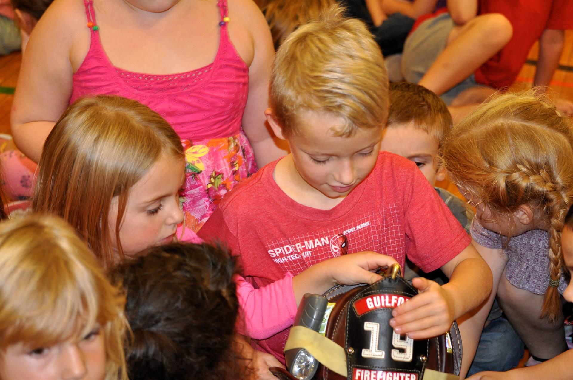 students check out a fire fighter hat.