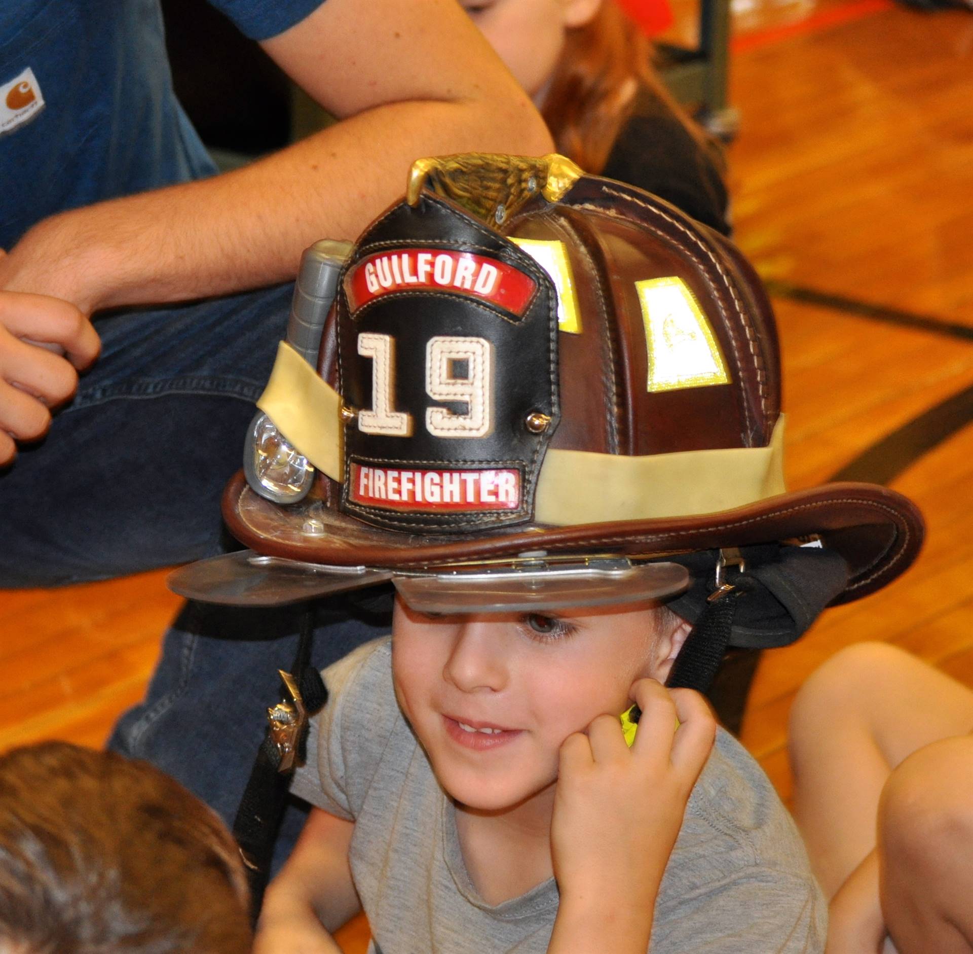 a student wears a firefighter hat!