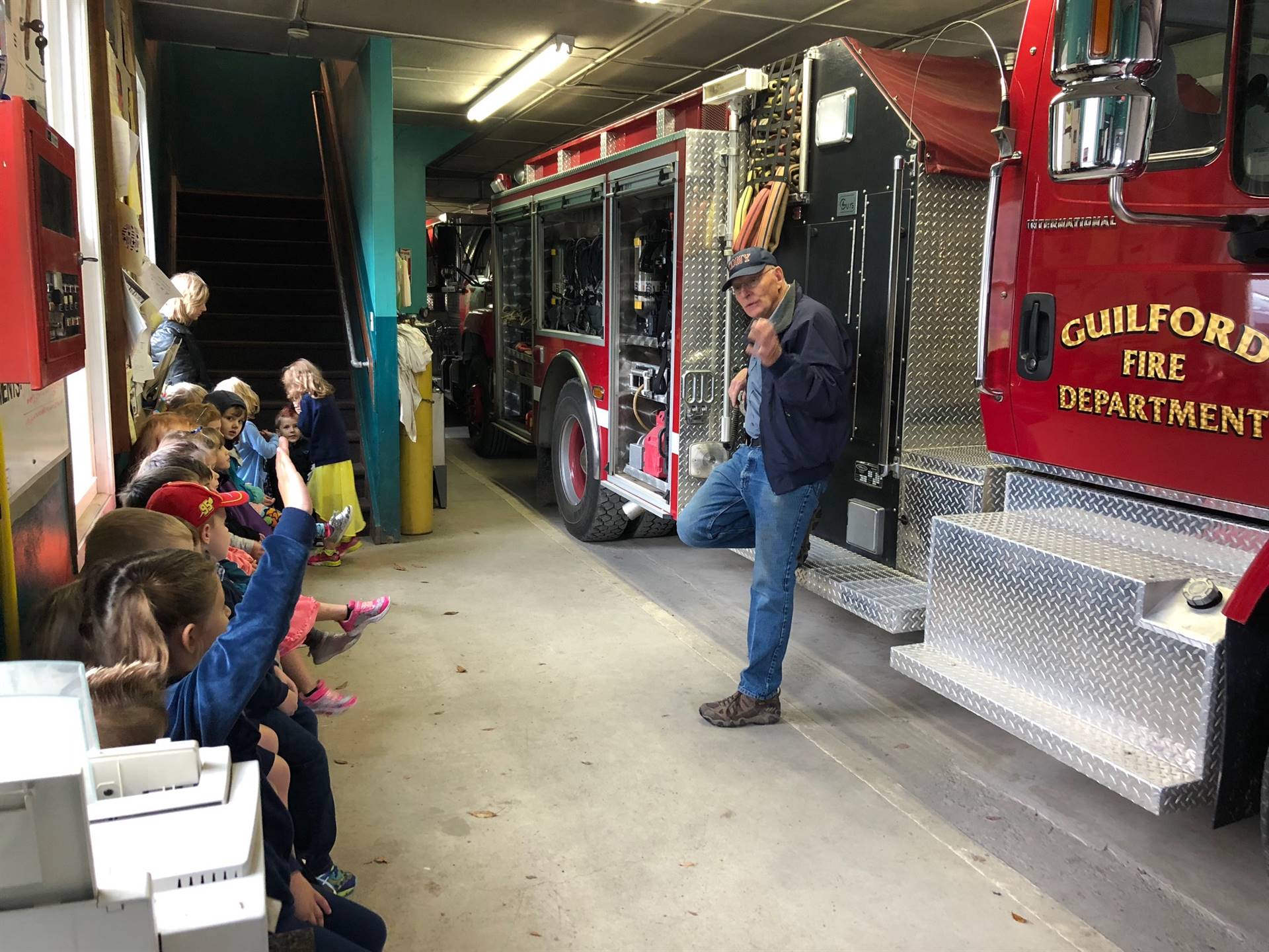 Fireman talks to students about fire safety.