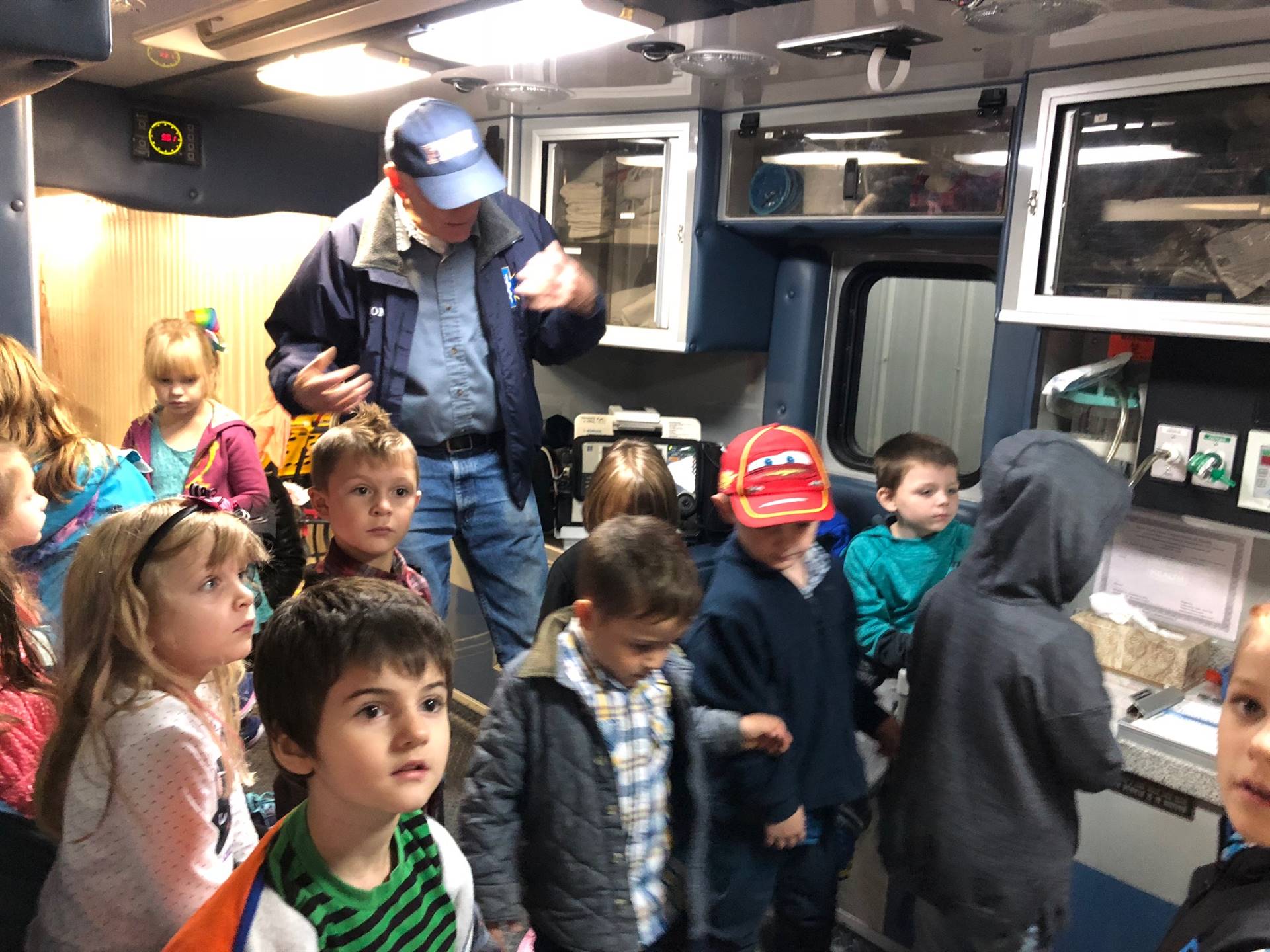 Fireman talks to students about fire safety at the fire station.