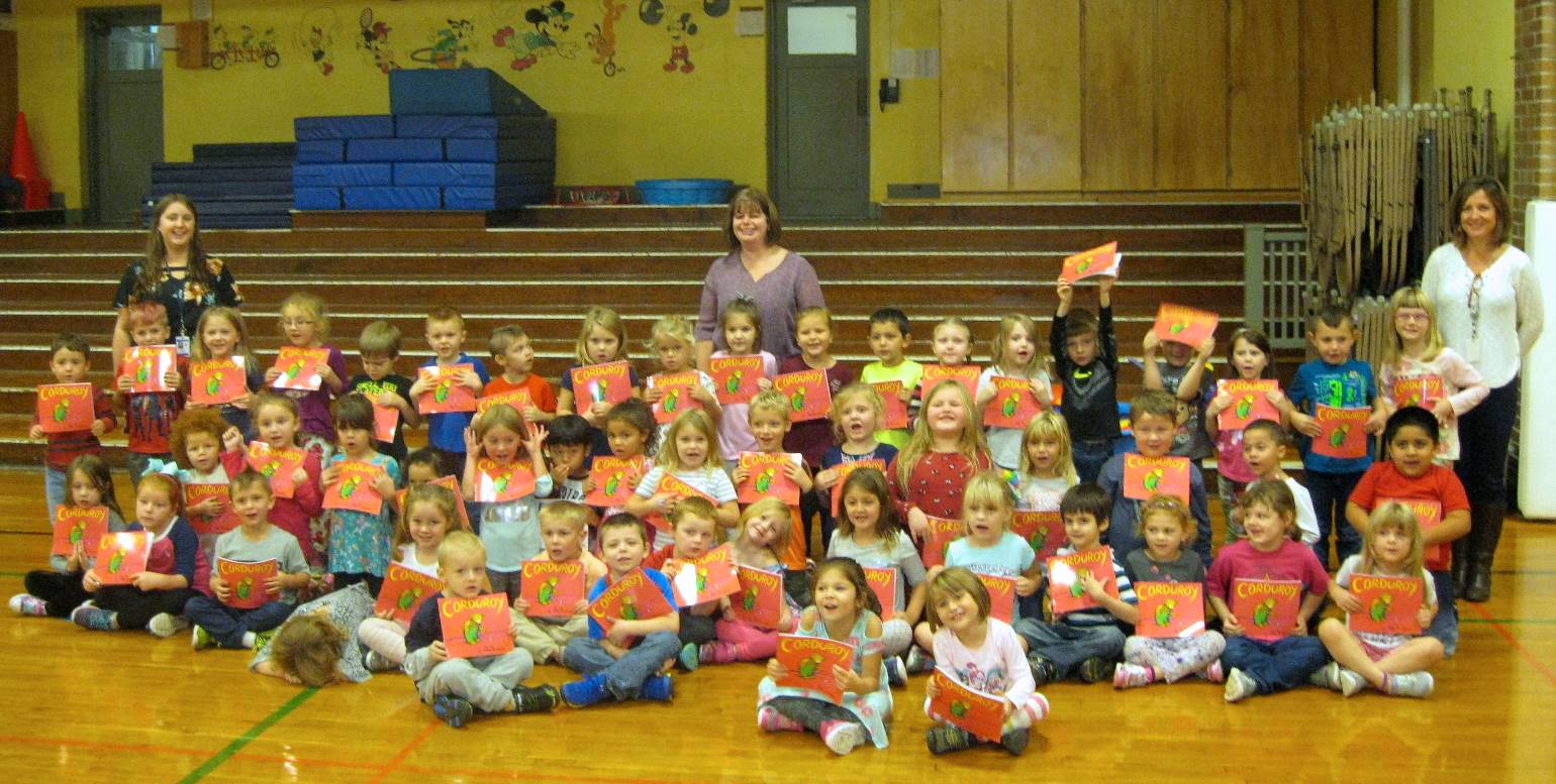 Kindergarten and teachers show off their free book, "Corduroy"