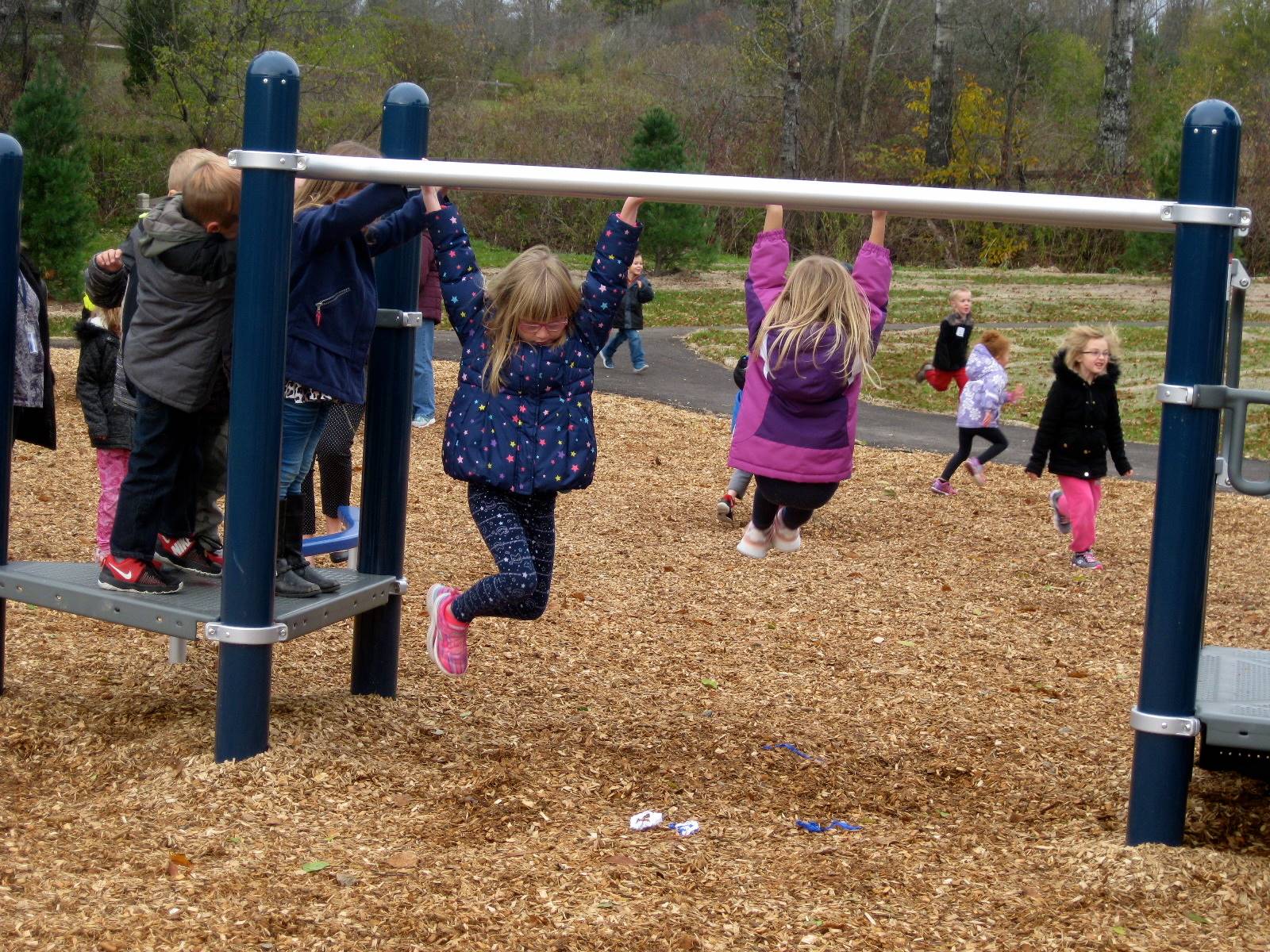 Children try the monkey bars.