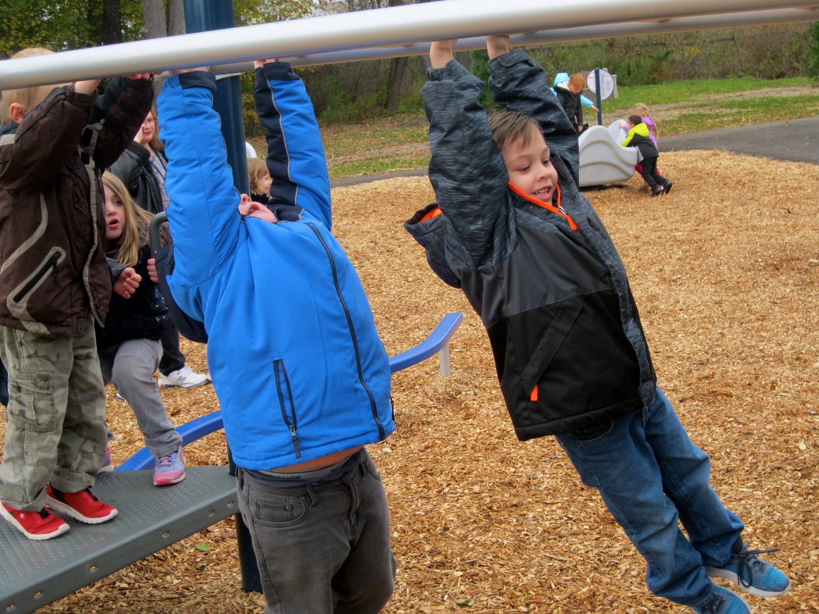 Children try the monkey bars.