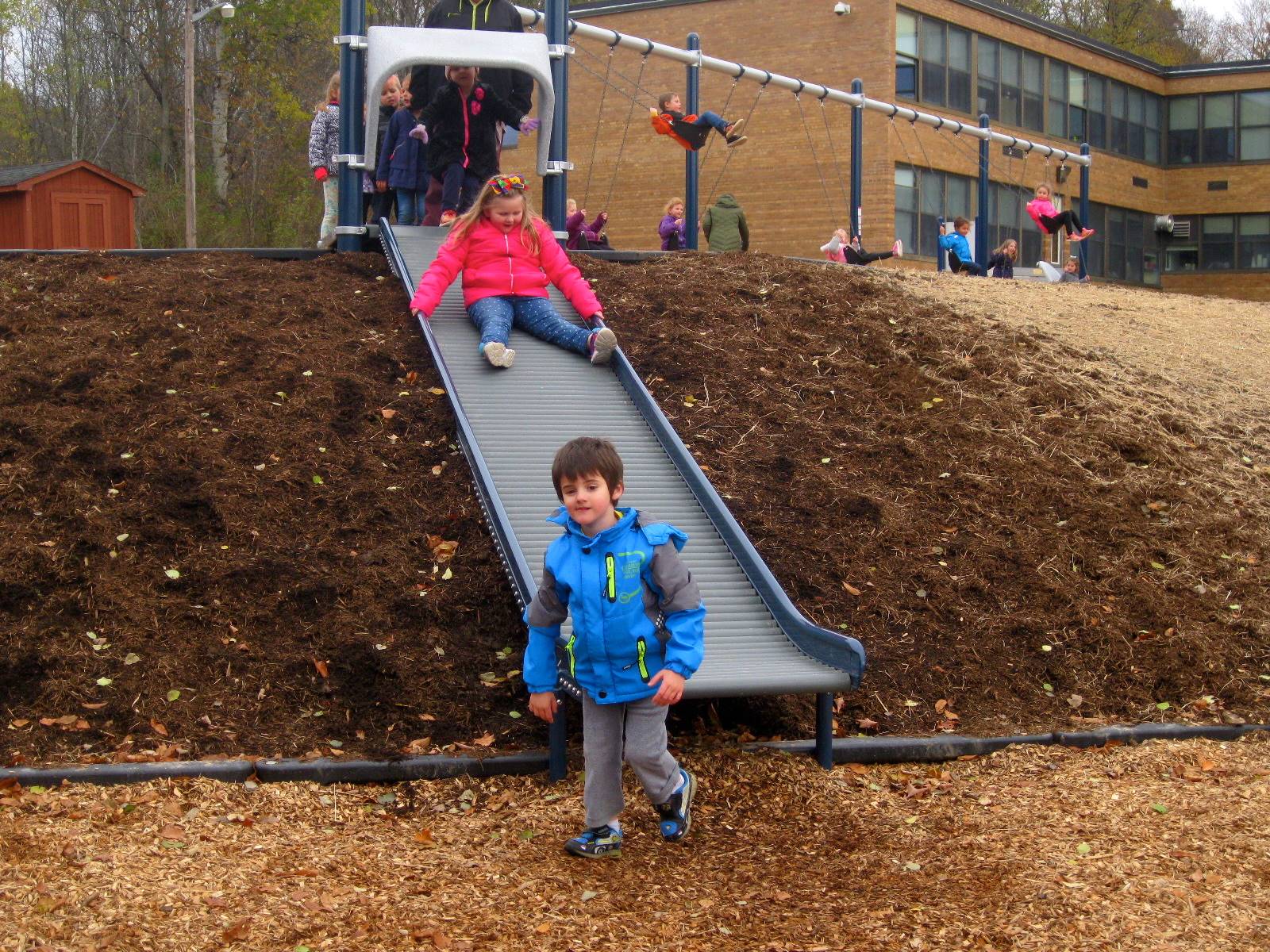 kids on roller slide.