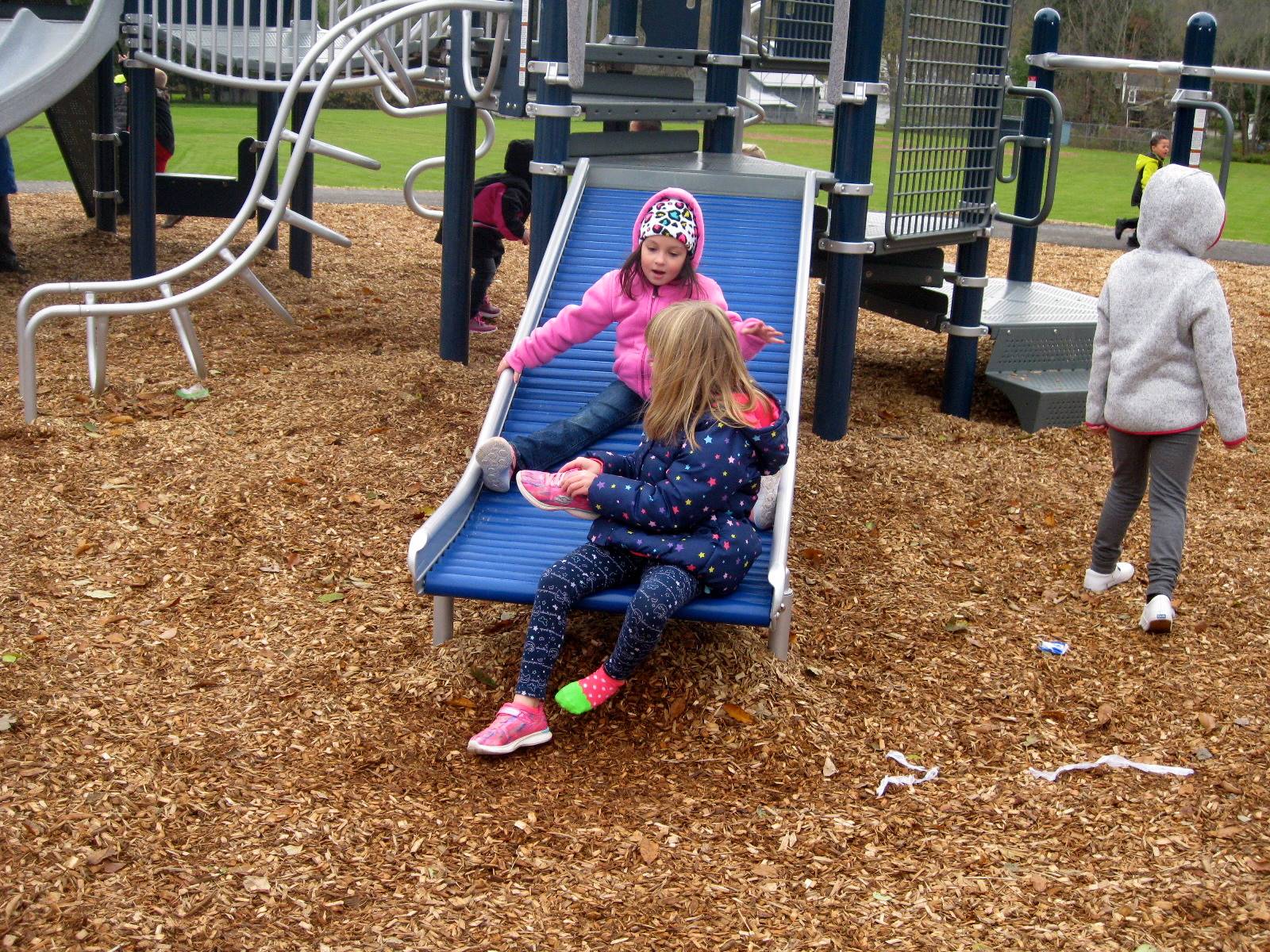 kids on roller slide.