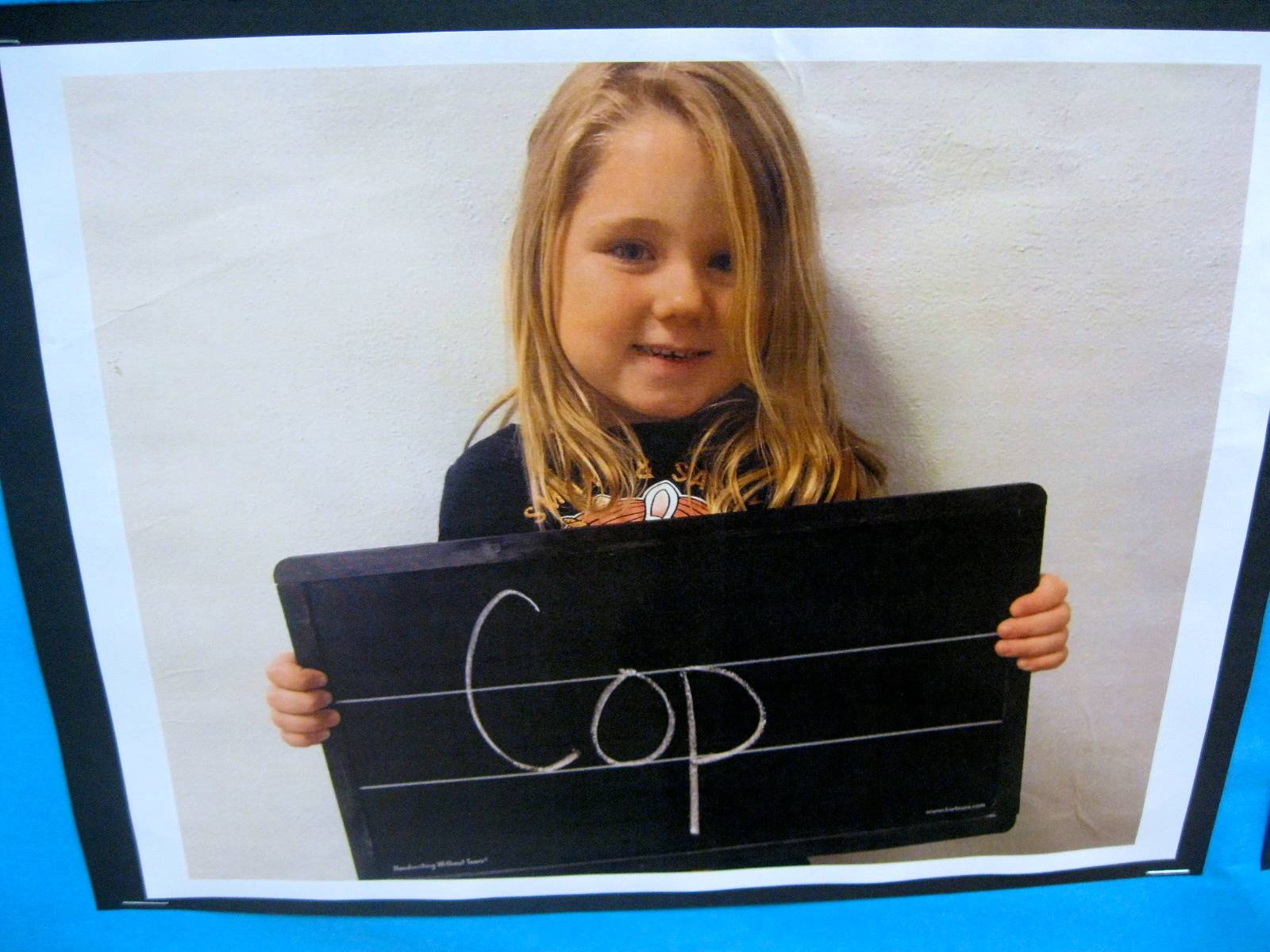 Child holding sign to show what they want to be when they grow up.