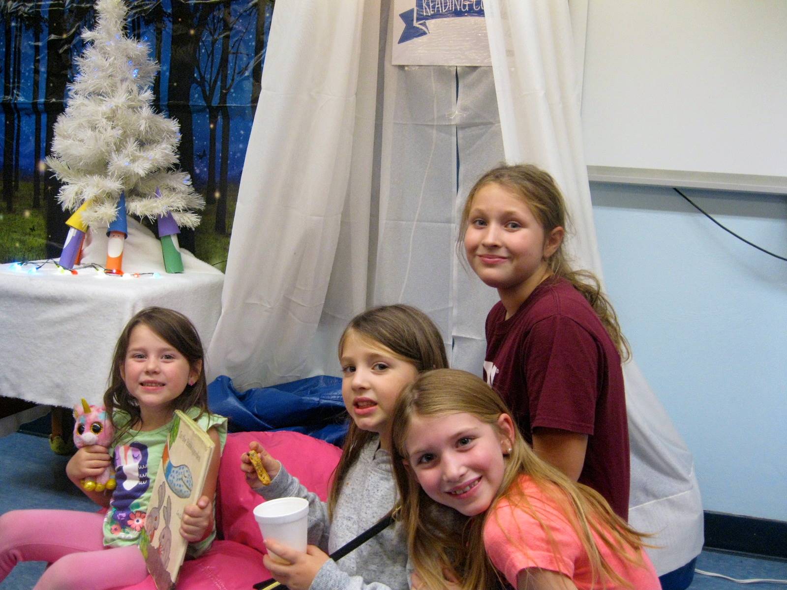 4 Children enjoy the "Book Nook" at Guilford's Open house book fair.