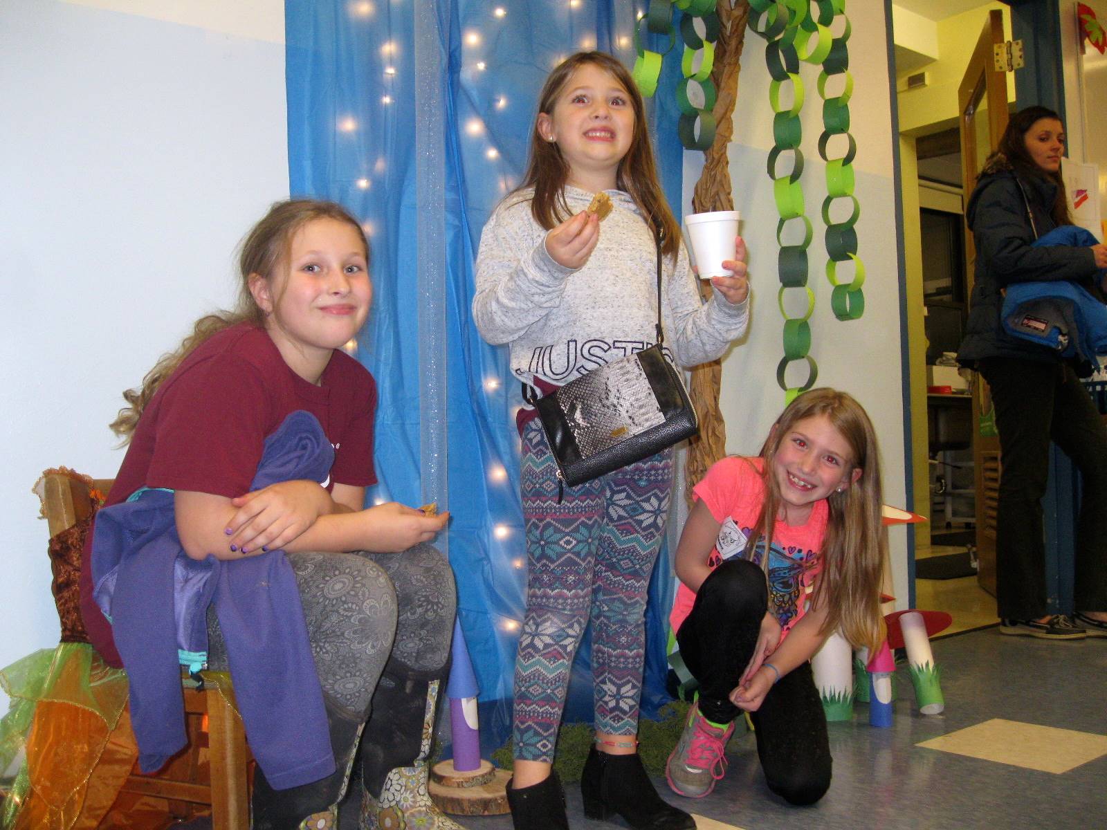 3 Children enjoy the photo corner in the enchanted  forest book fair. 