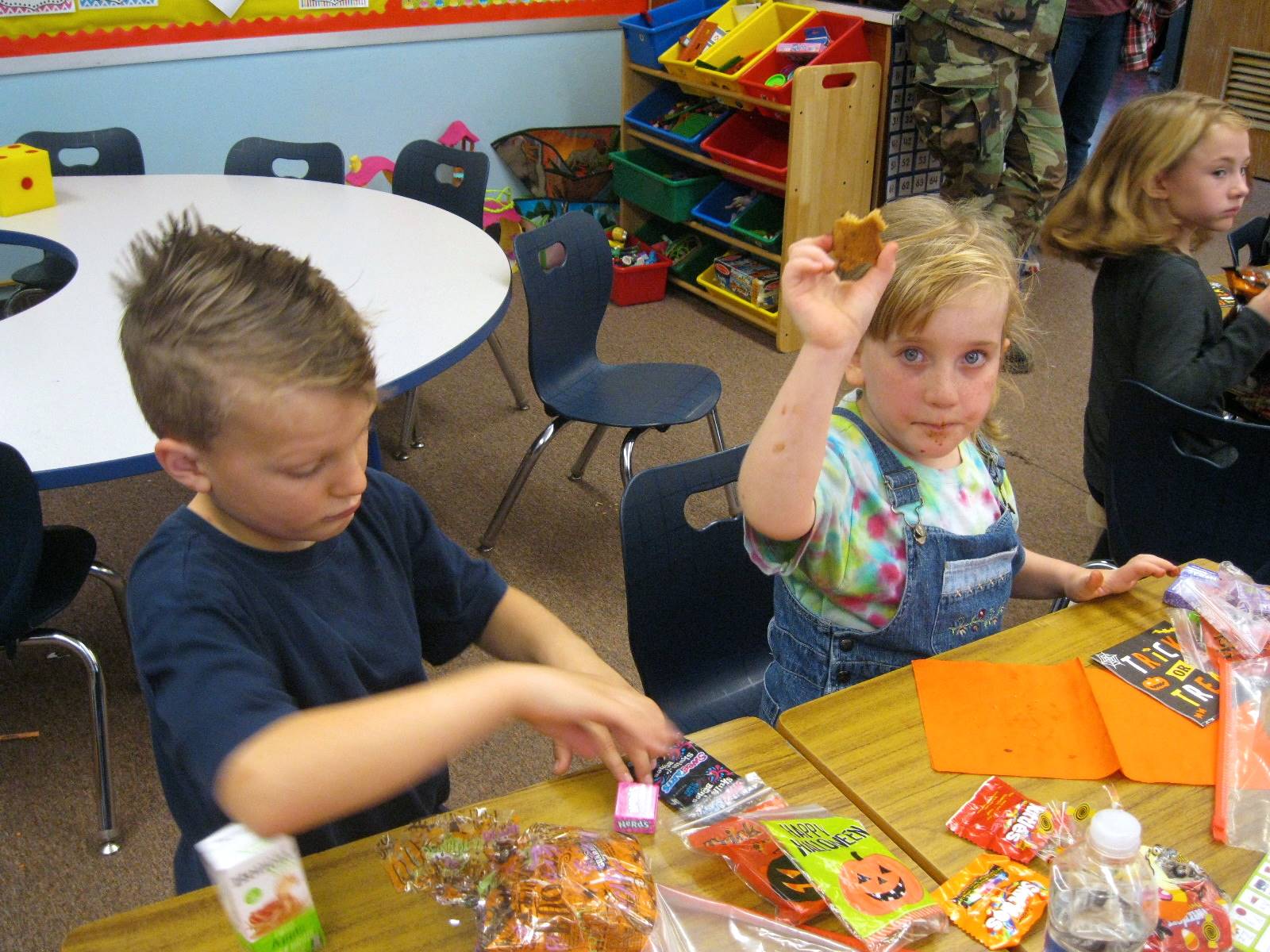 2 students show their fun snacks. 