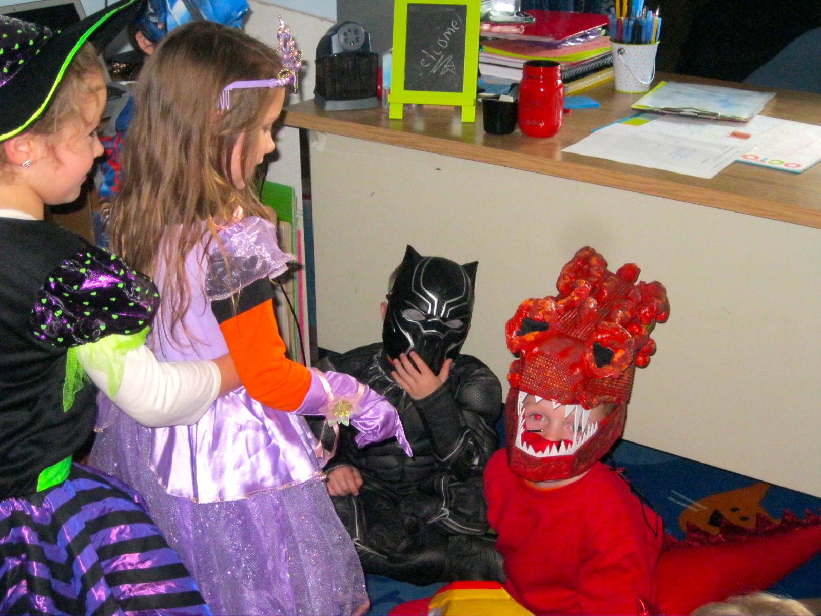 students dressed up. A princess sticks her finger out at a dragon?