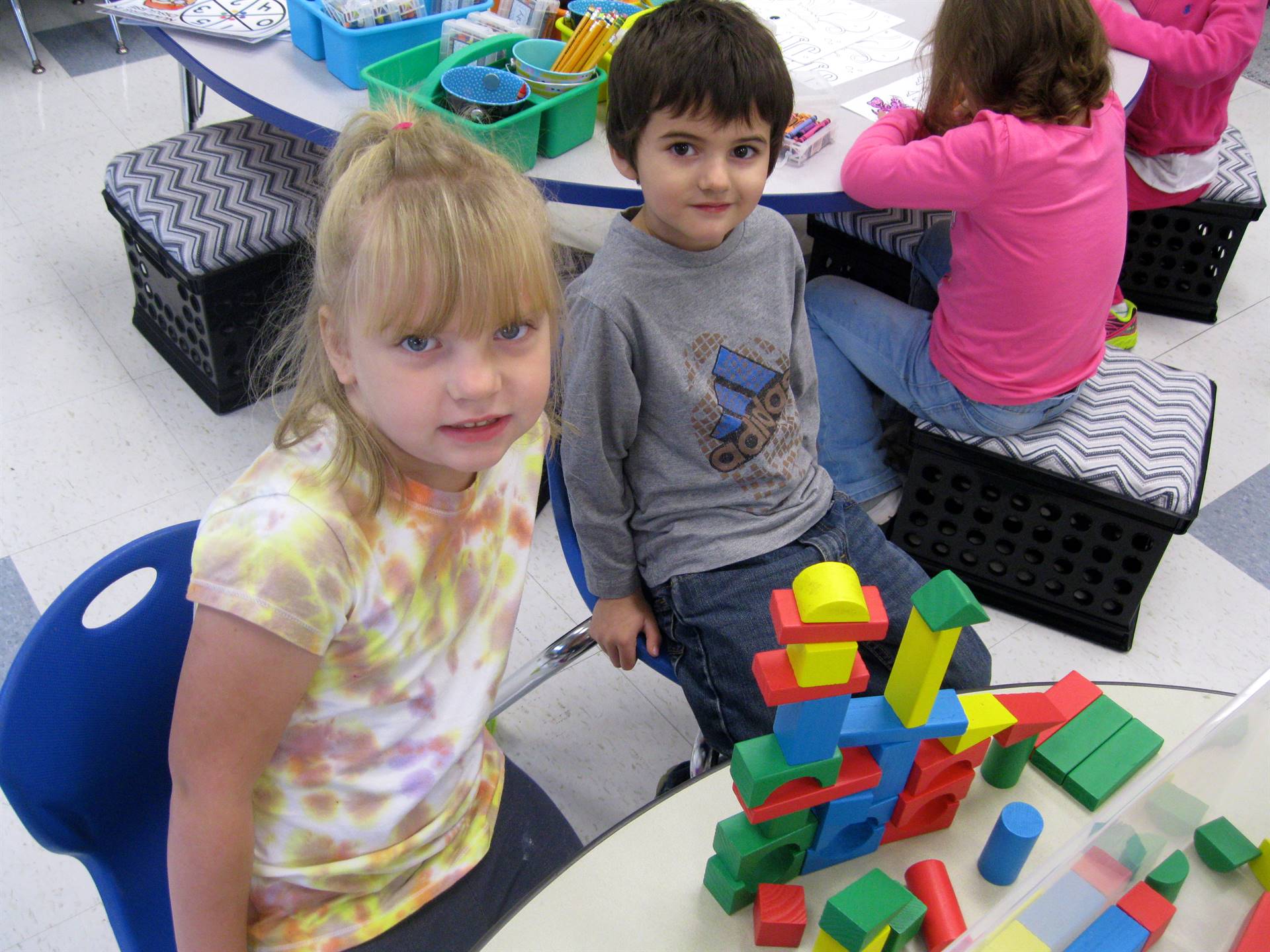 2 students show off their building.