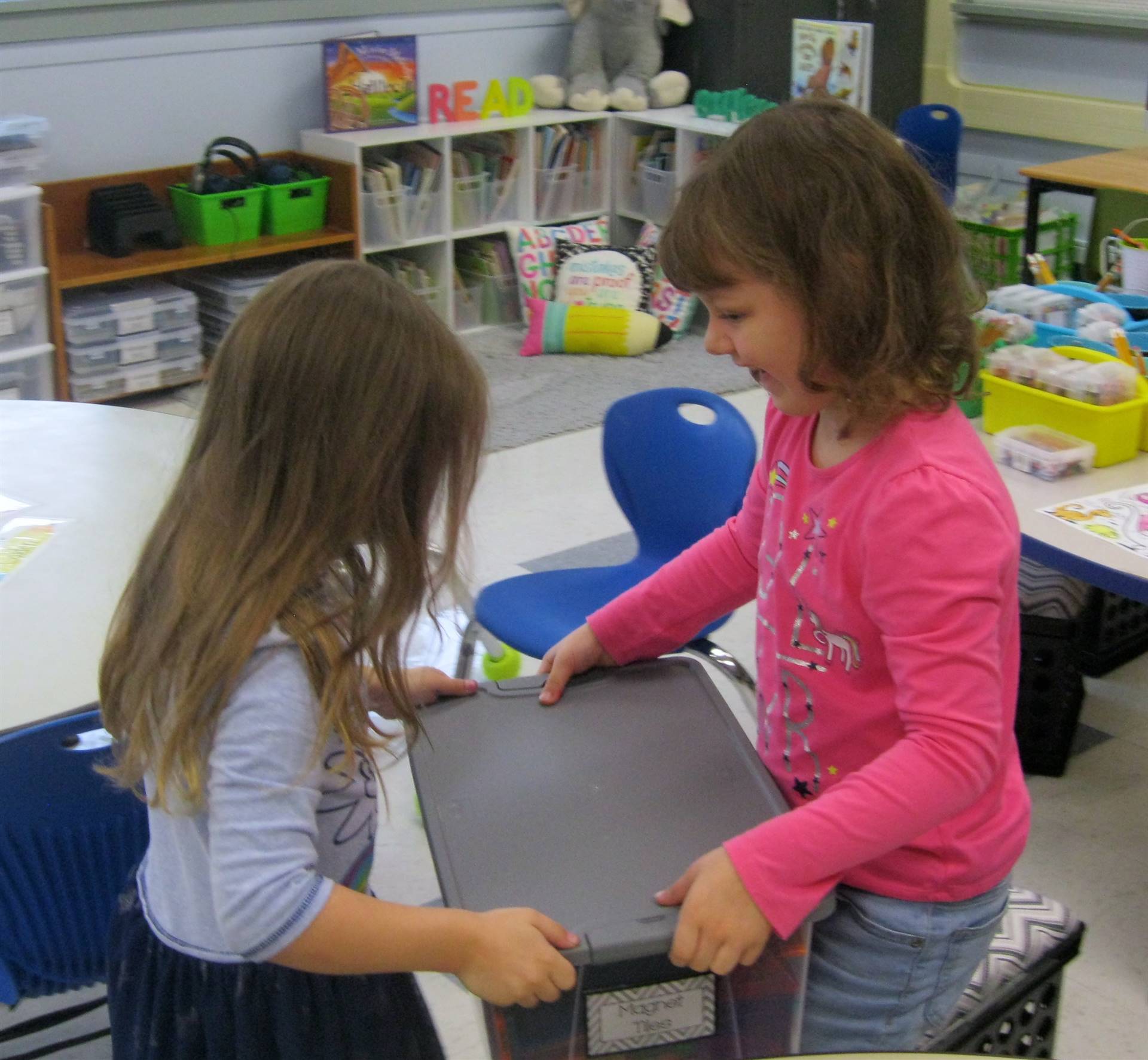 2 students clean up together.