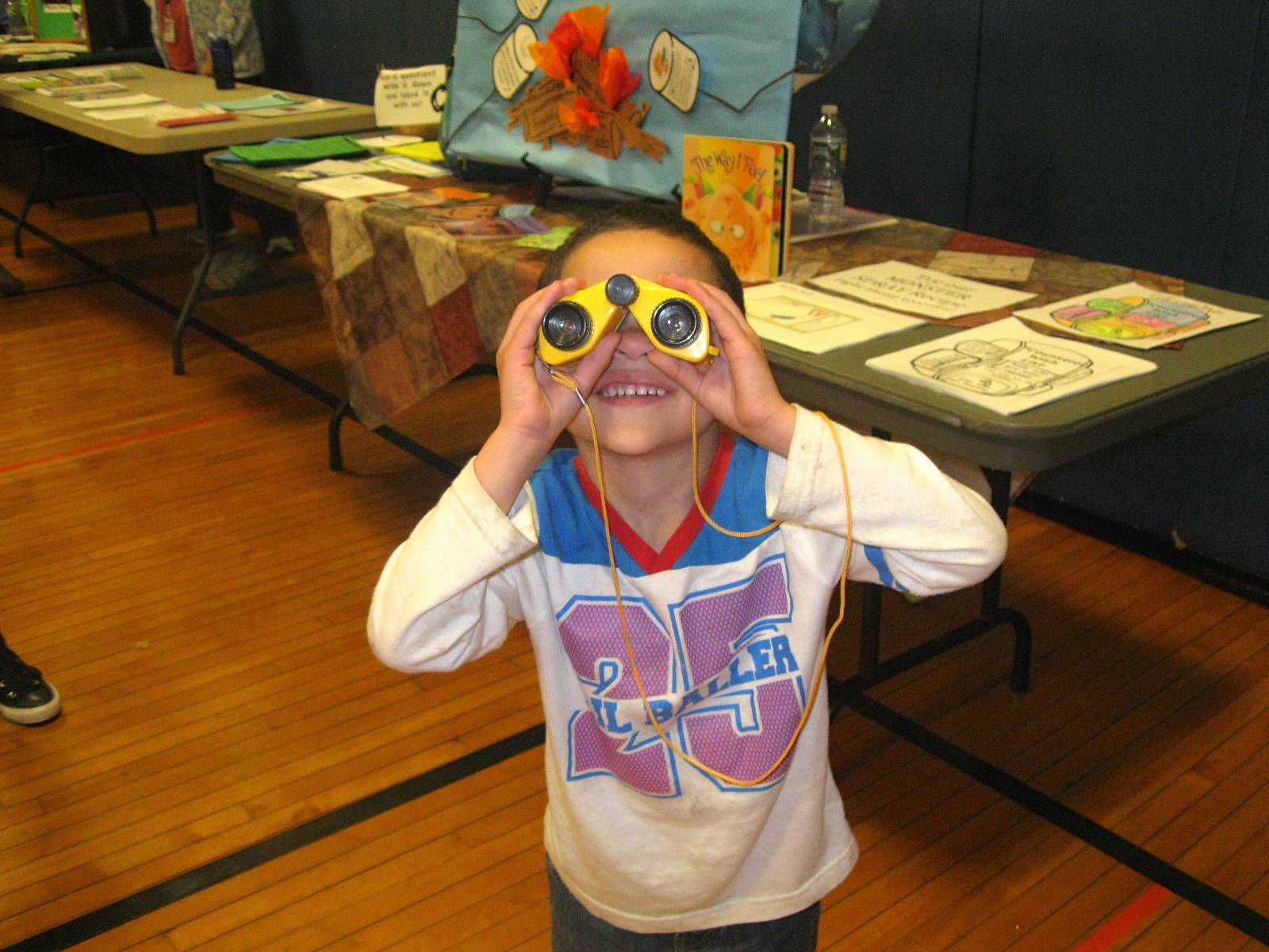 Child using binoculars to look for good behavior!