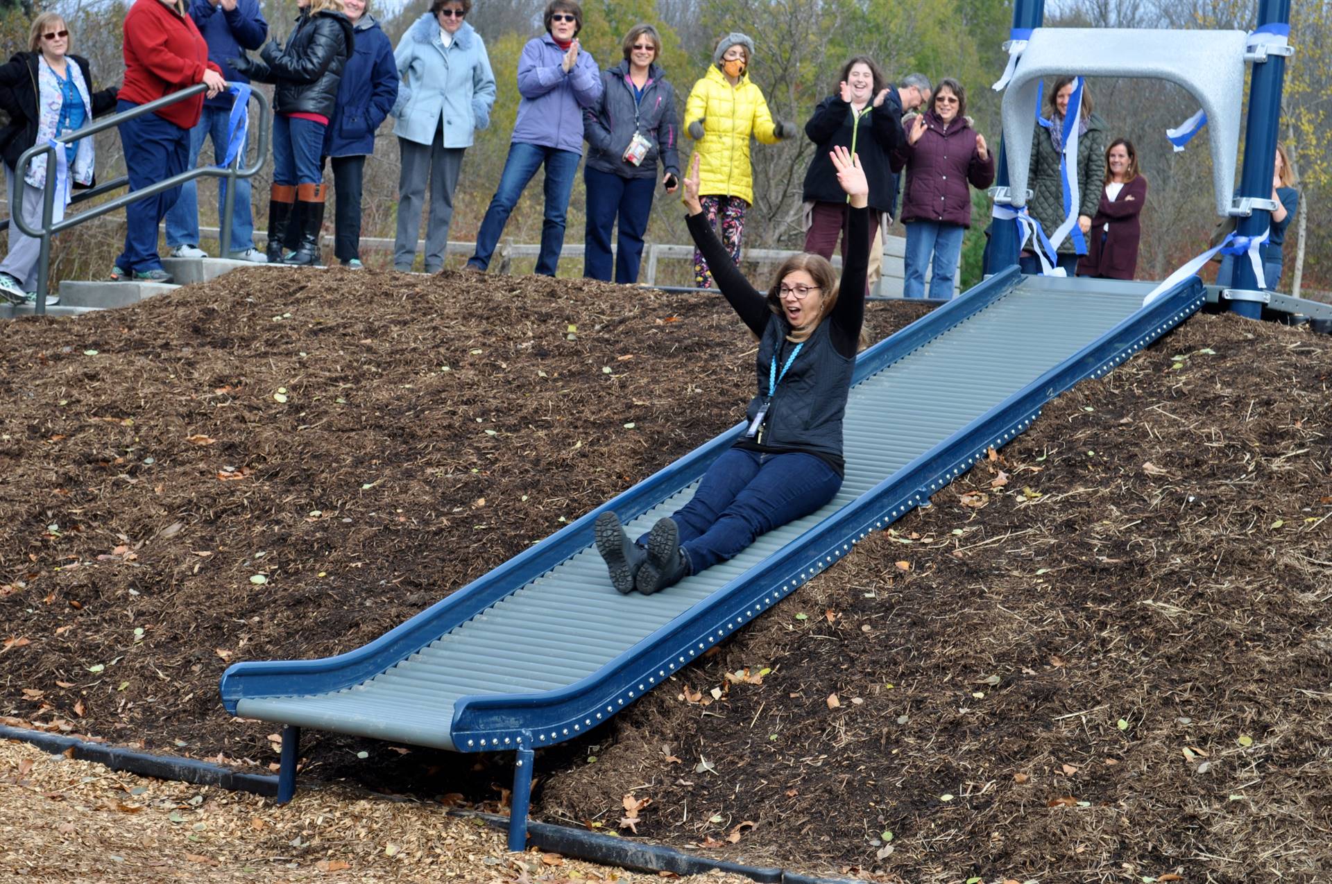 Mrs. Maynard, school principal having fun going down that slide.