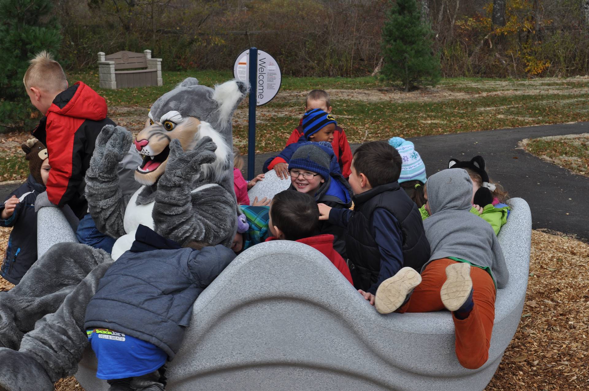 Felix Bobcat and students in merry go round.