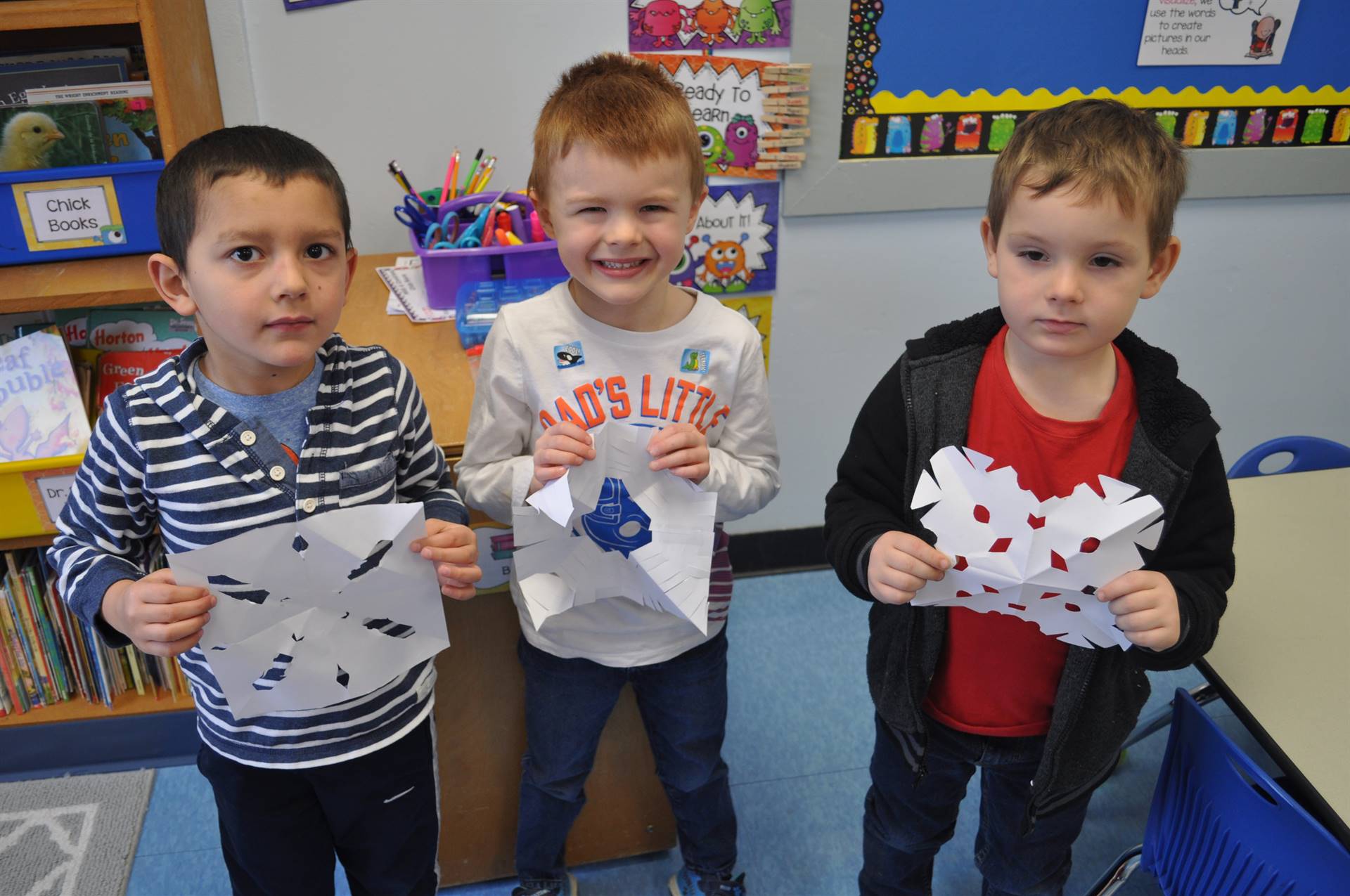 3 students show snowflakes.