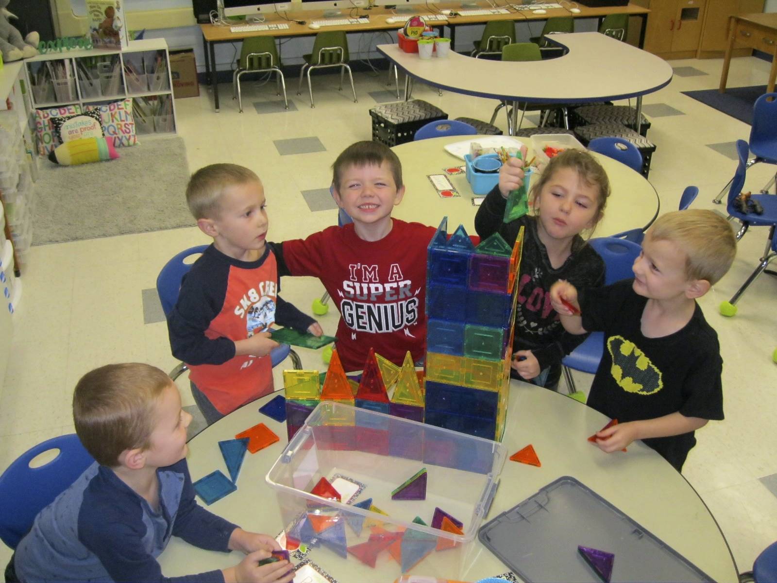 5 kindergarteners build together.