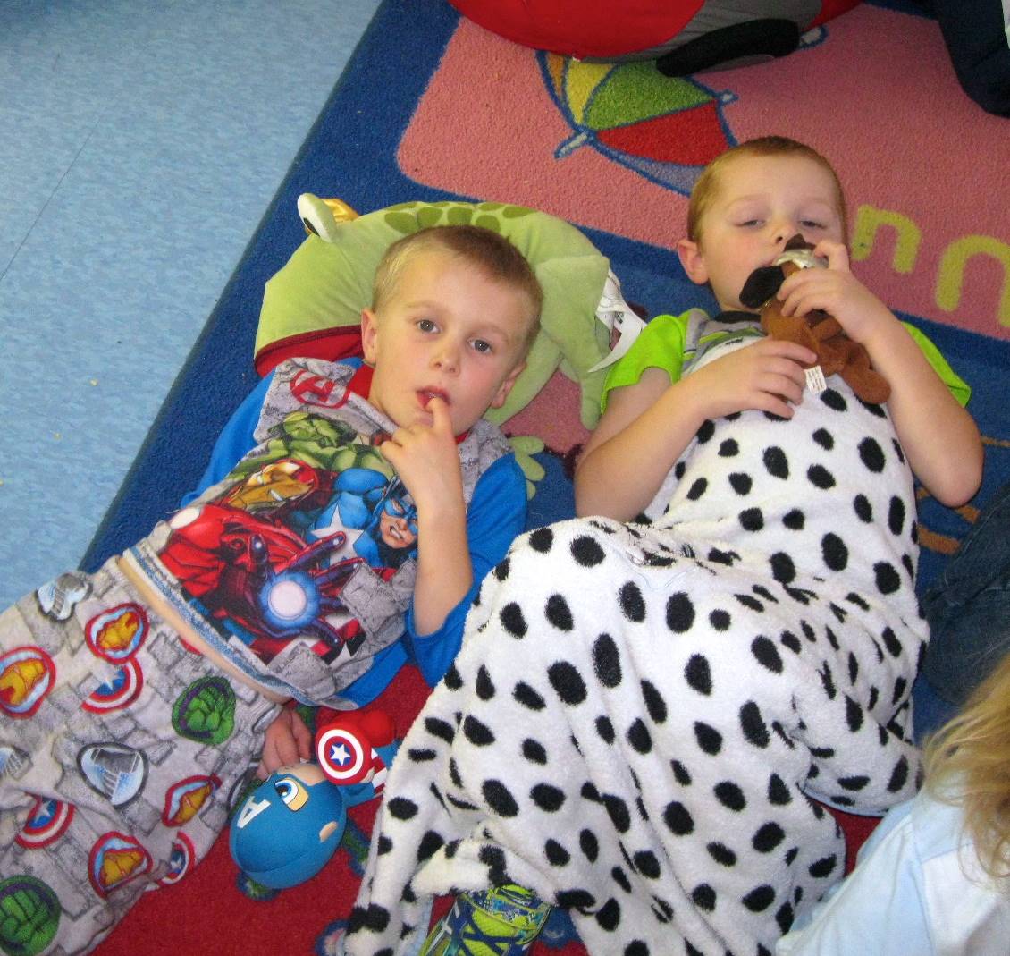 2 Children relax at  PAJAMA Party time.