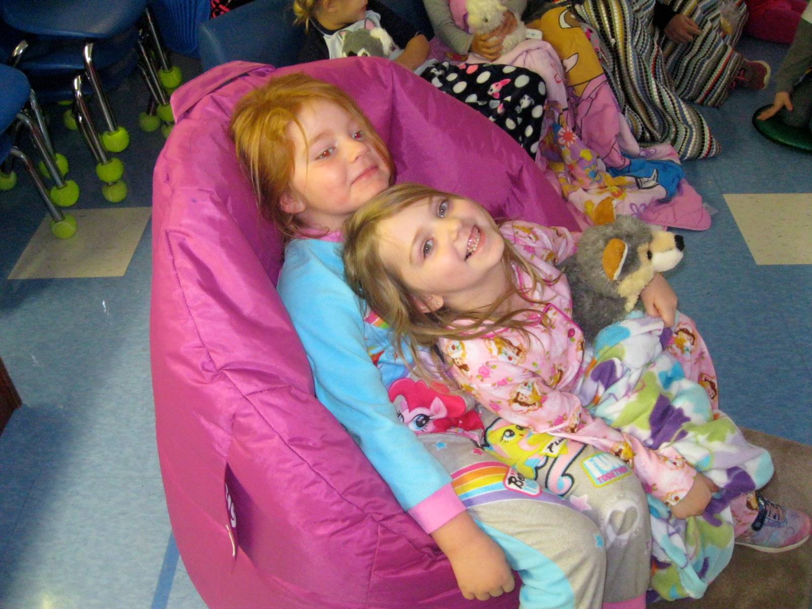 2 students enjoy PAJAMA Party with blankets and stuffy's!