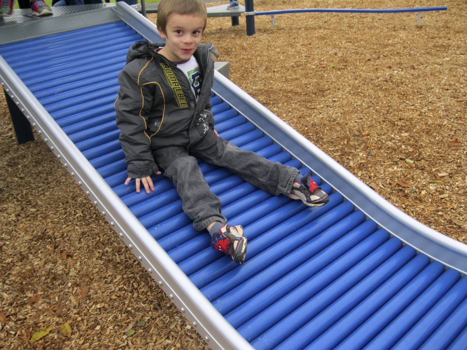 a student slides on roller slide.