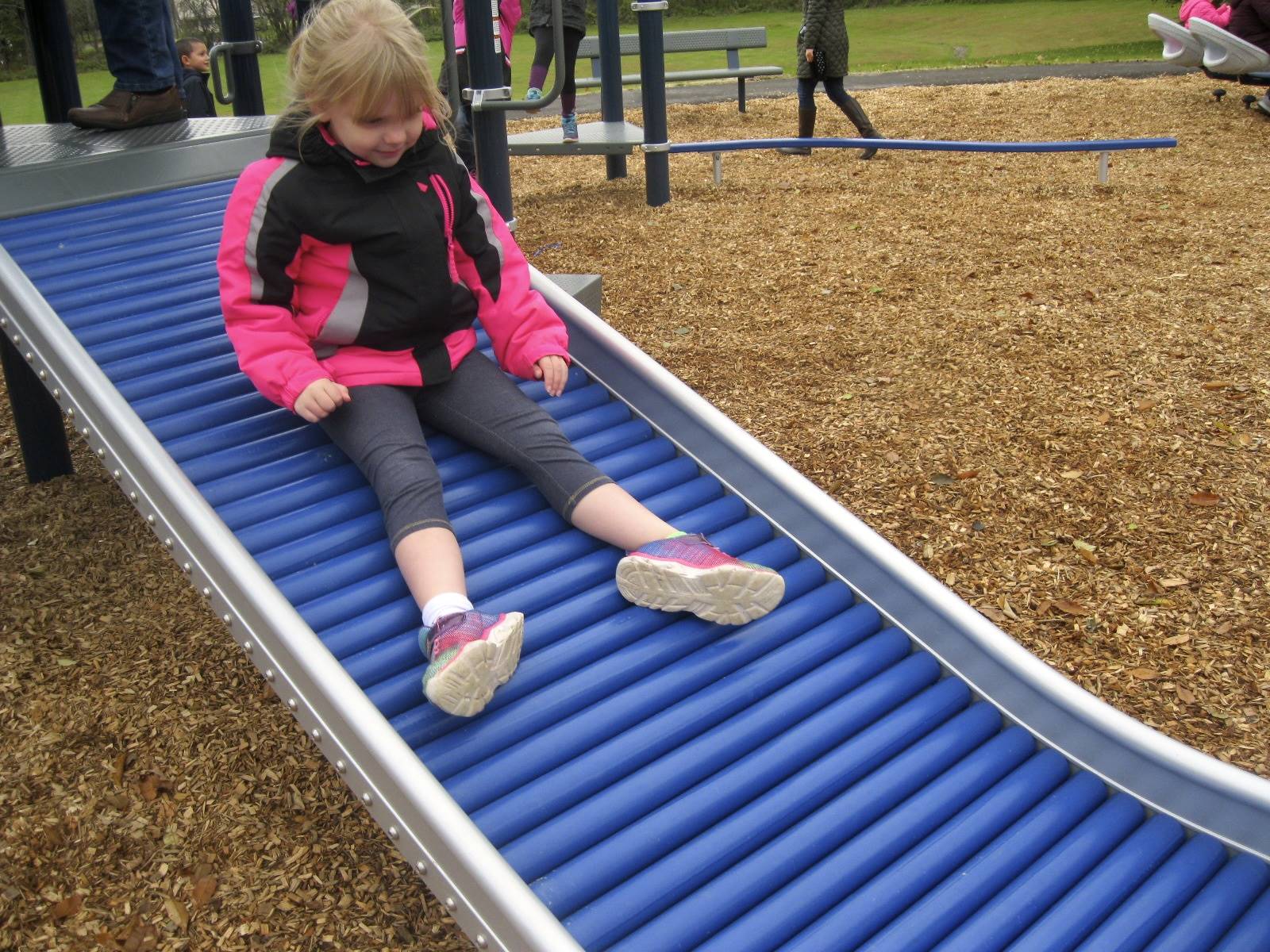 a student slides on roller slide.