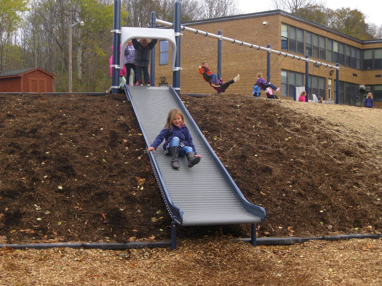 a student slides on roller slide.