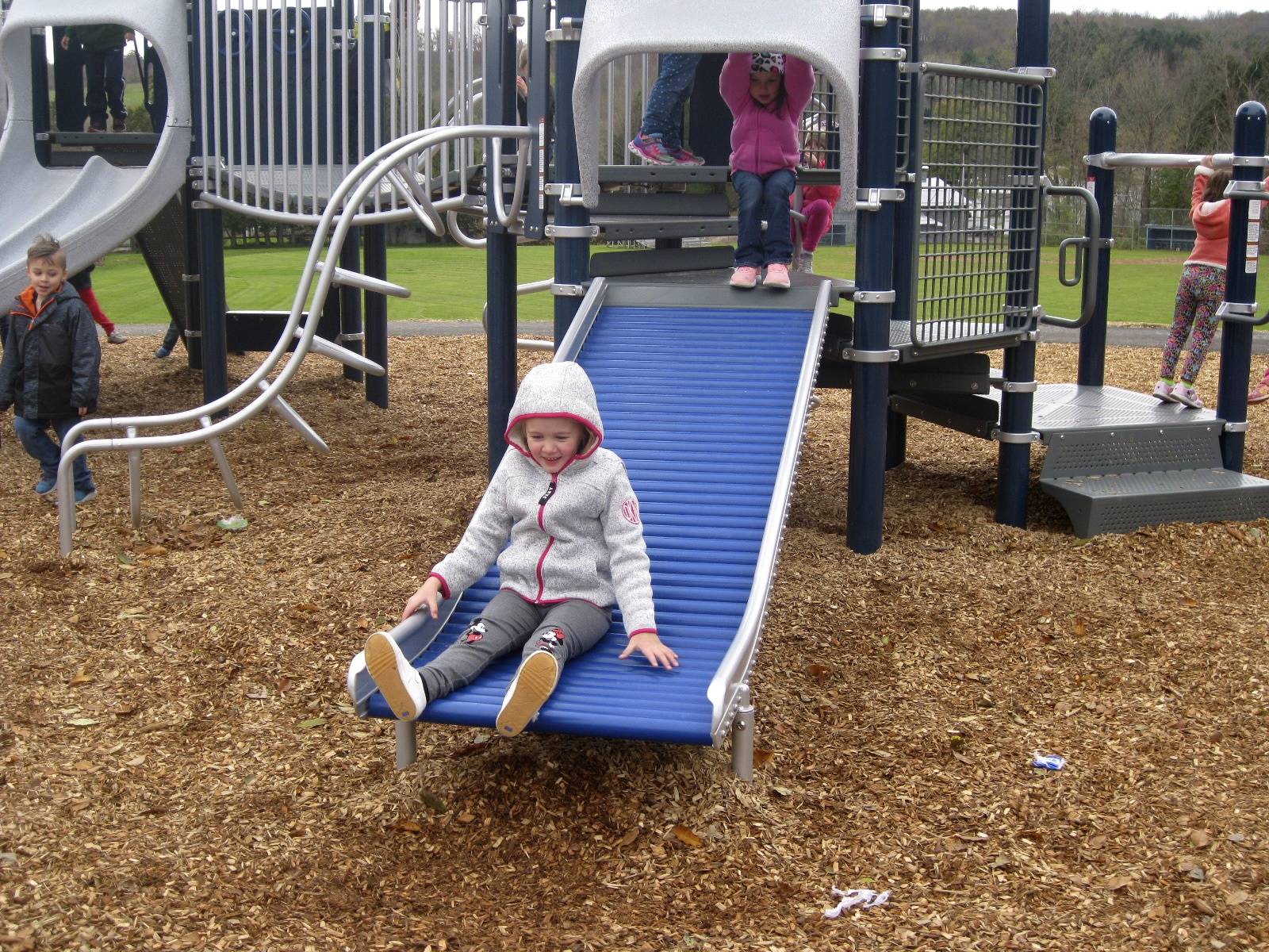 a student slides on roller slide.