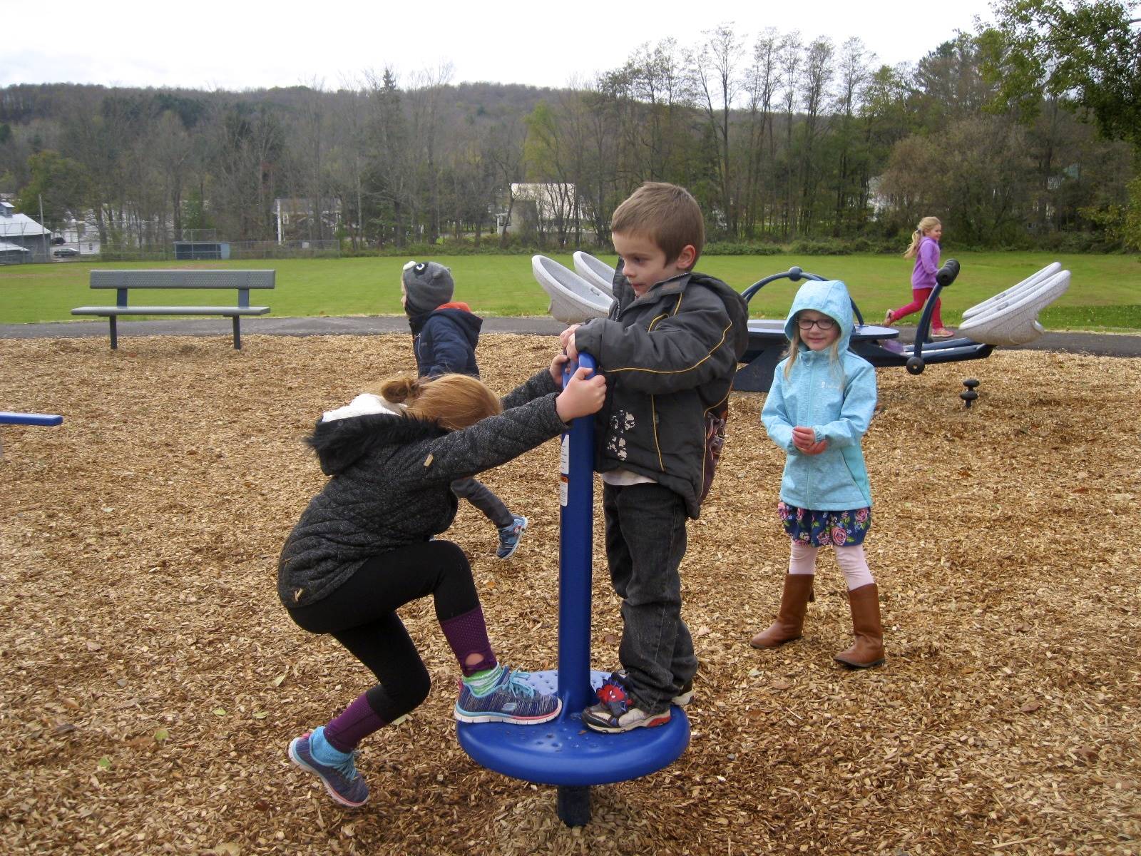 Cooperation! 1 student helps another twirl and spin.