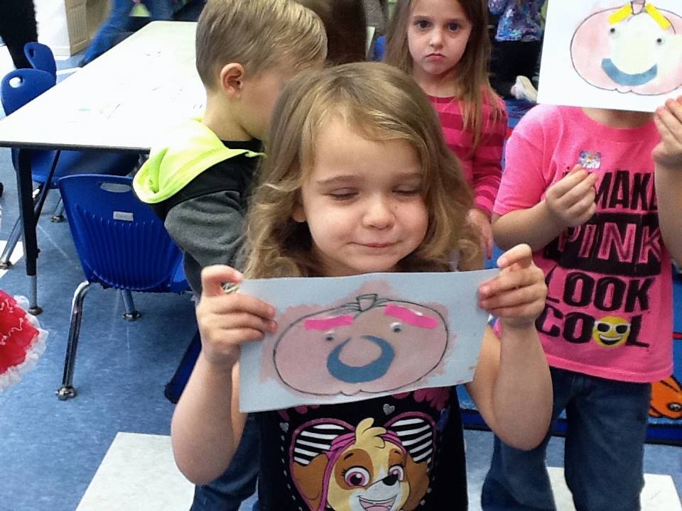 A student matches her emotion with her pumpkin's emotion.