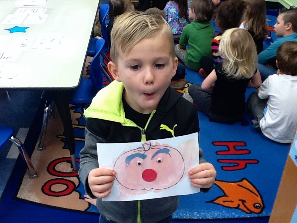 A student matches his emotion with his pumpkin's emotion.