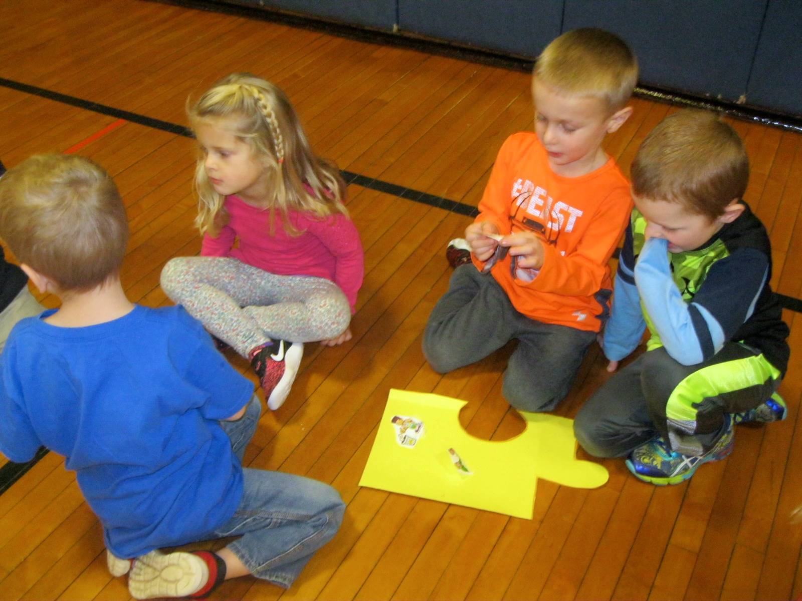 4 students put pictures on a puzzle piece!