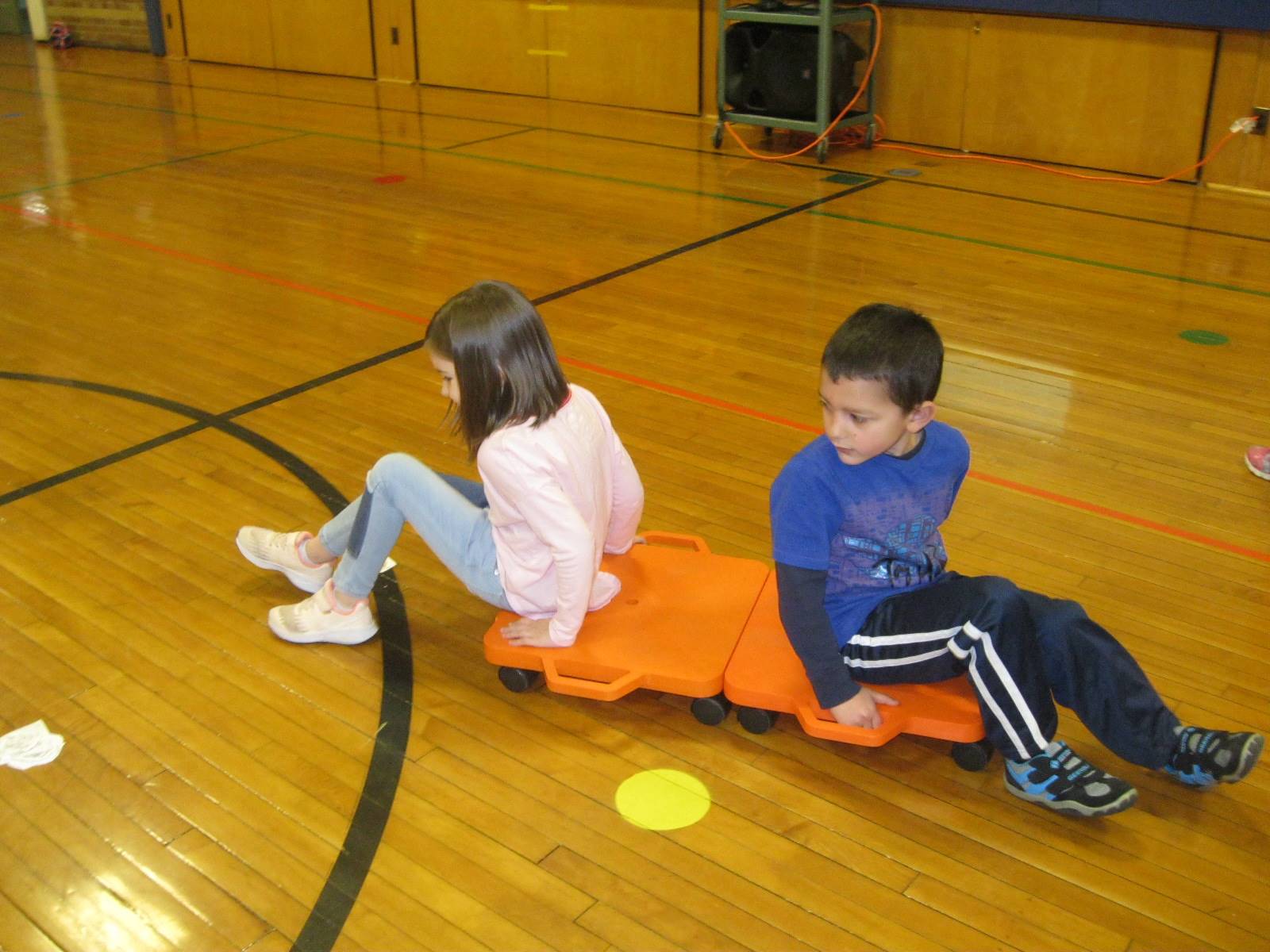 2 students on a scooter.