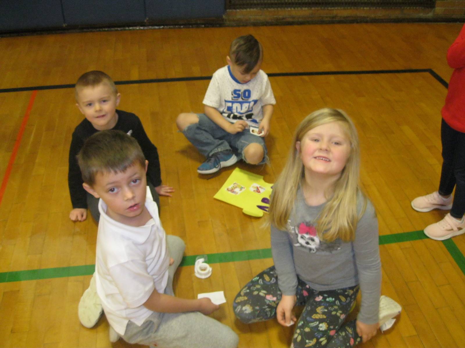 4 students work on adding responsible pictures to their puzzle piece!