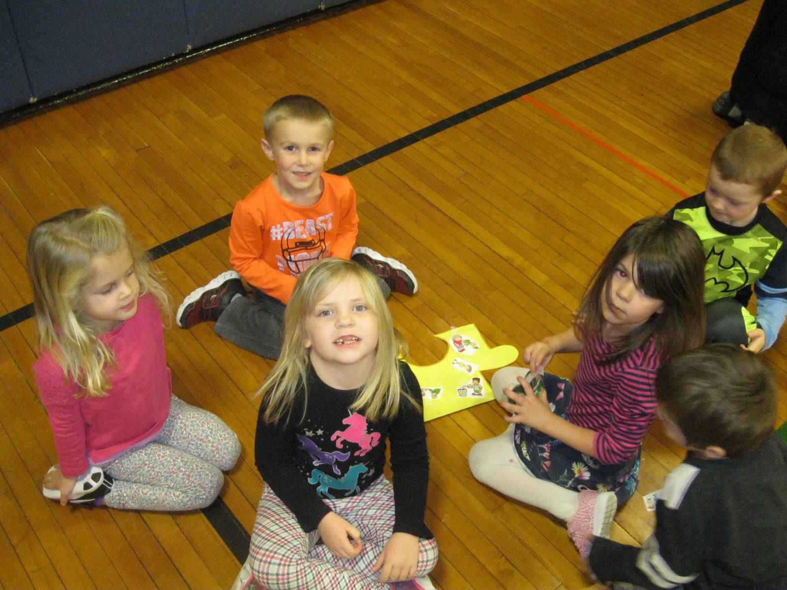 5 Students smile as they complete their puzzle piece.