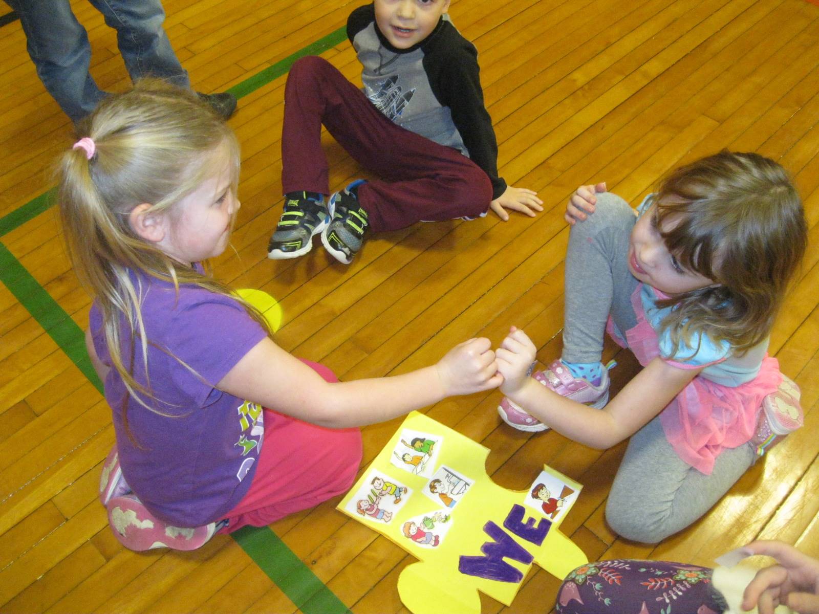 2 students give each other a knuckle pound that means, "WE DID IT"!