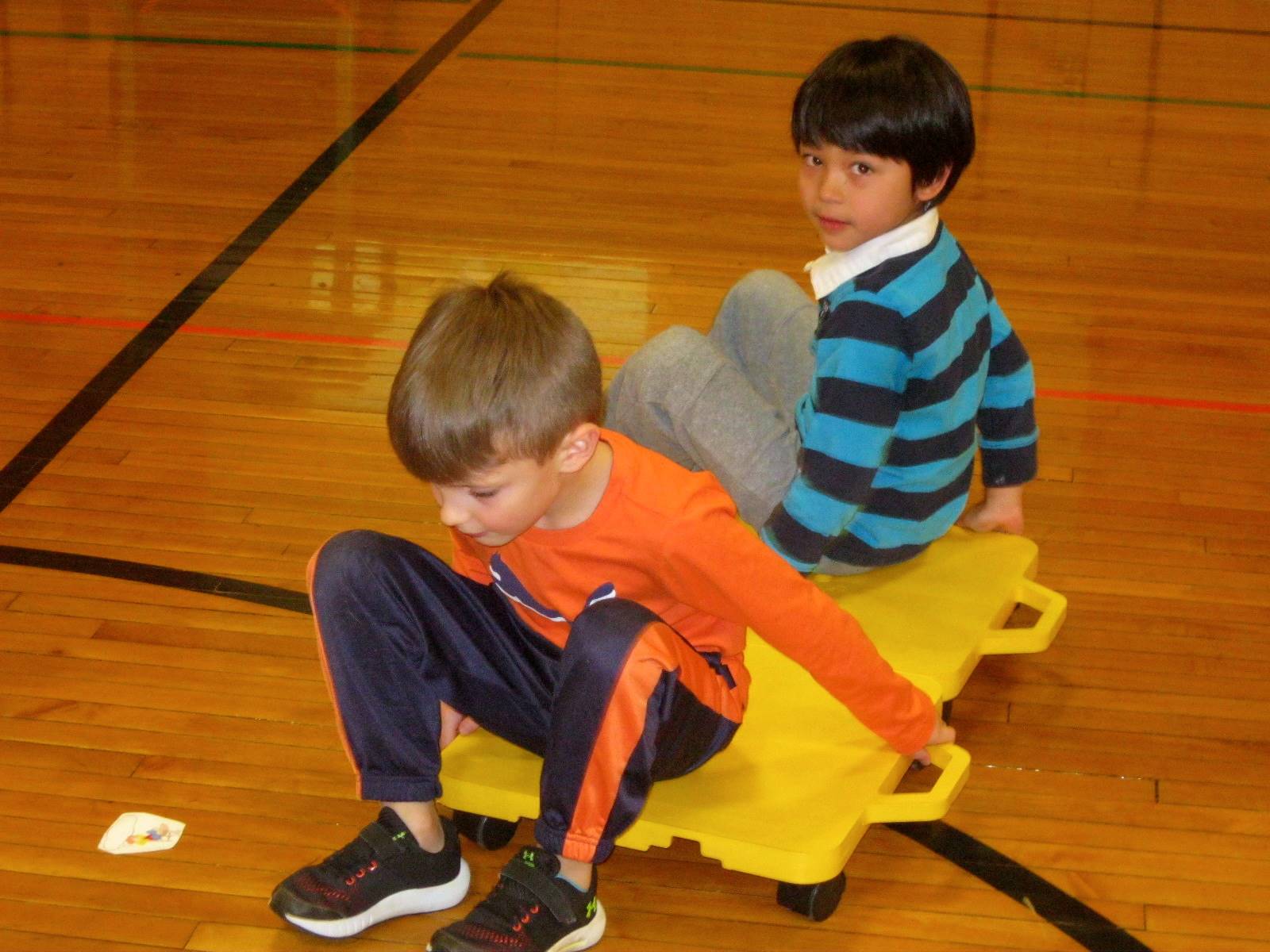 2 students on a scooter.