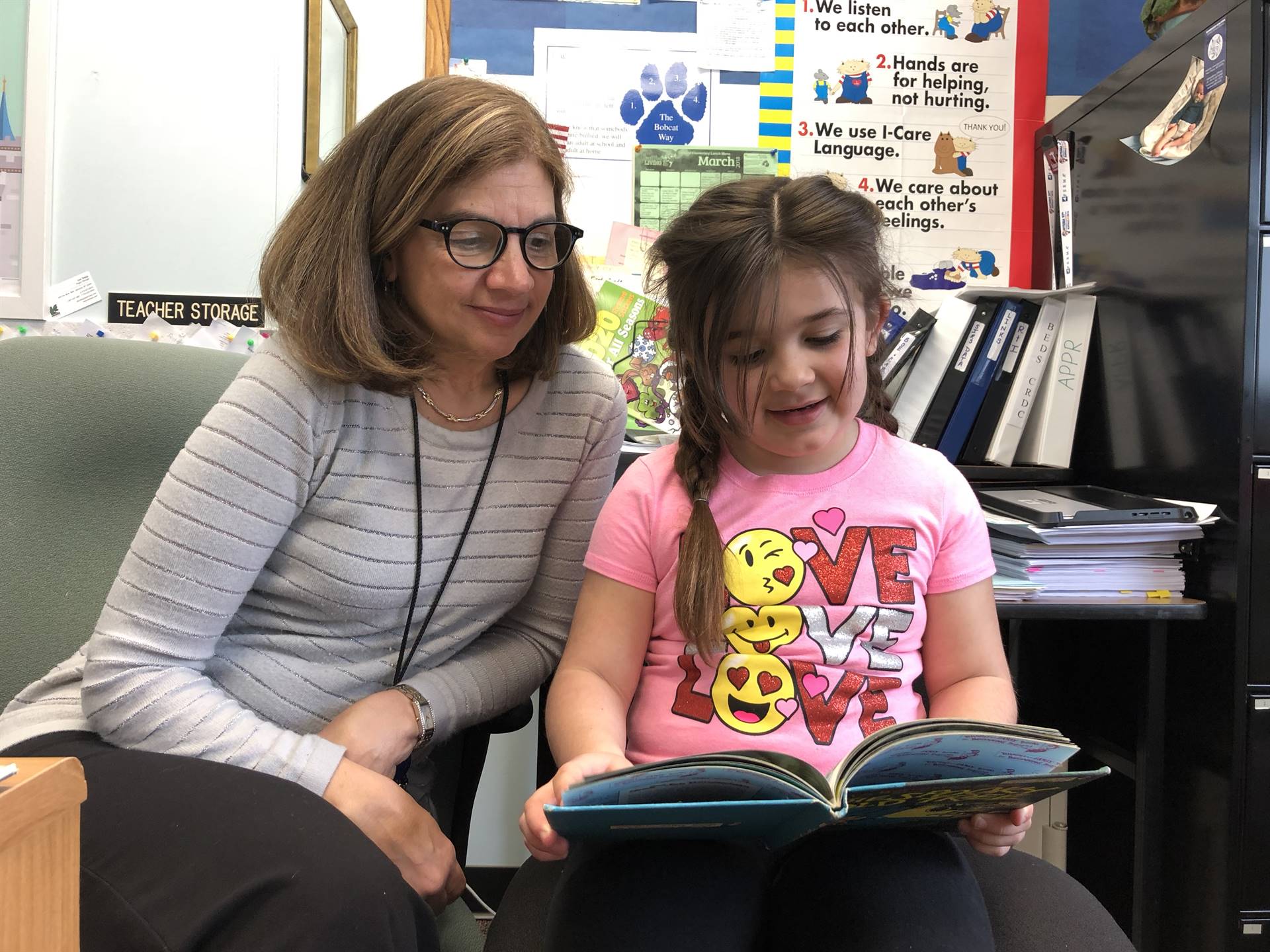 Principal Maynard and first grader read together