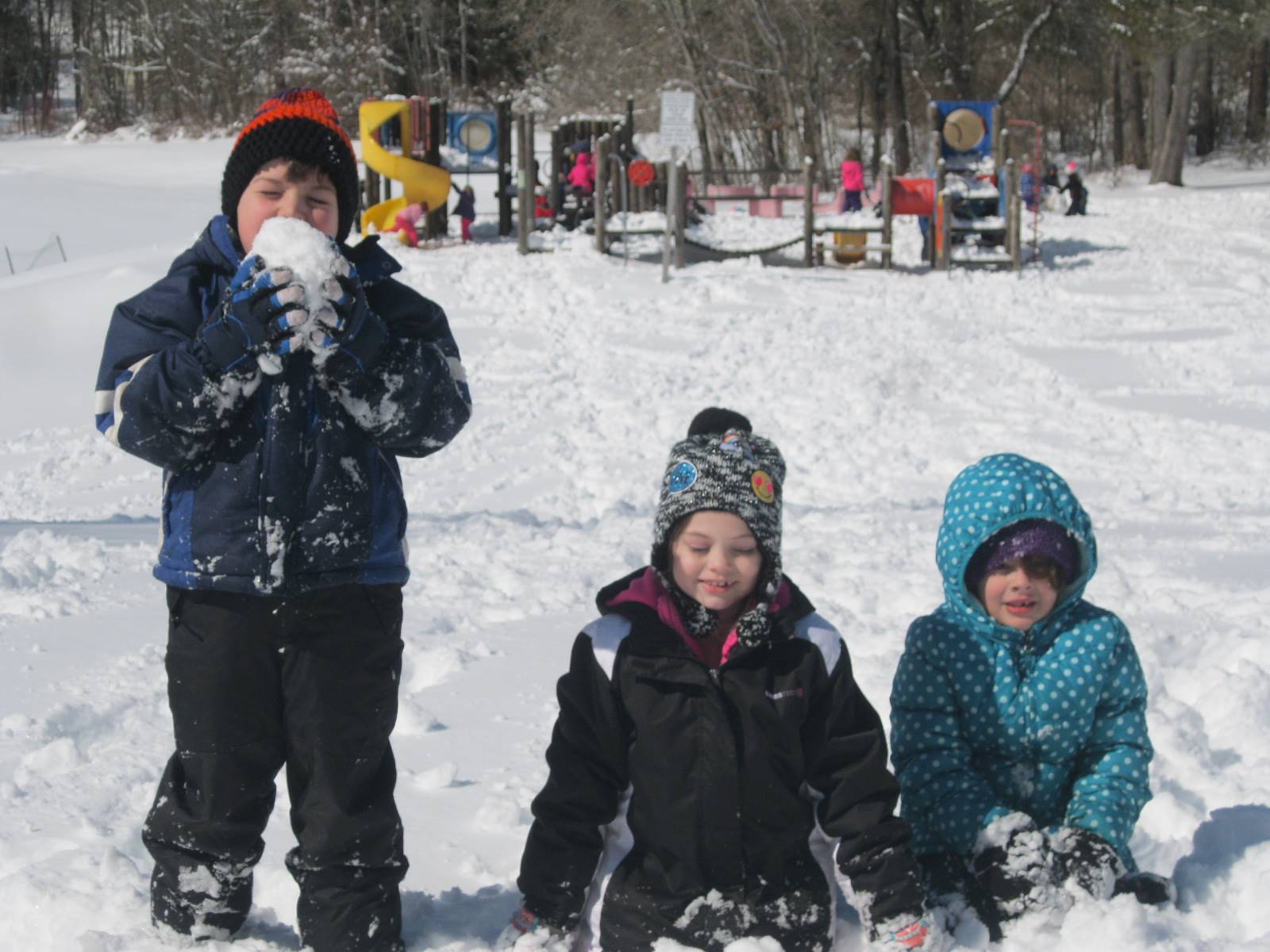 Children sitting in the snow.