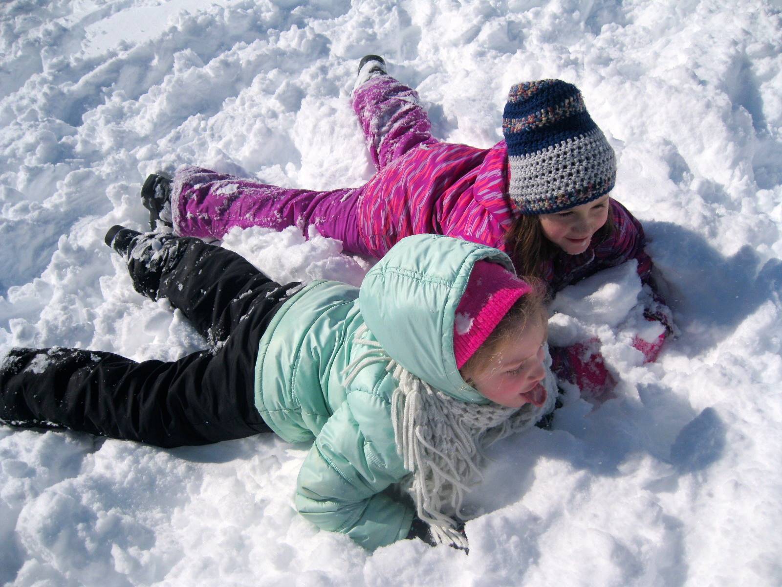 Children lay in the snow.