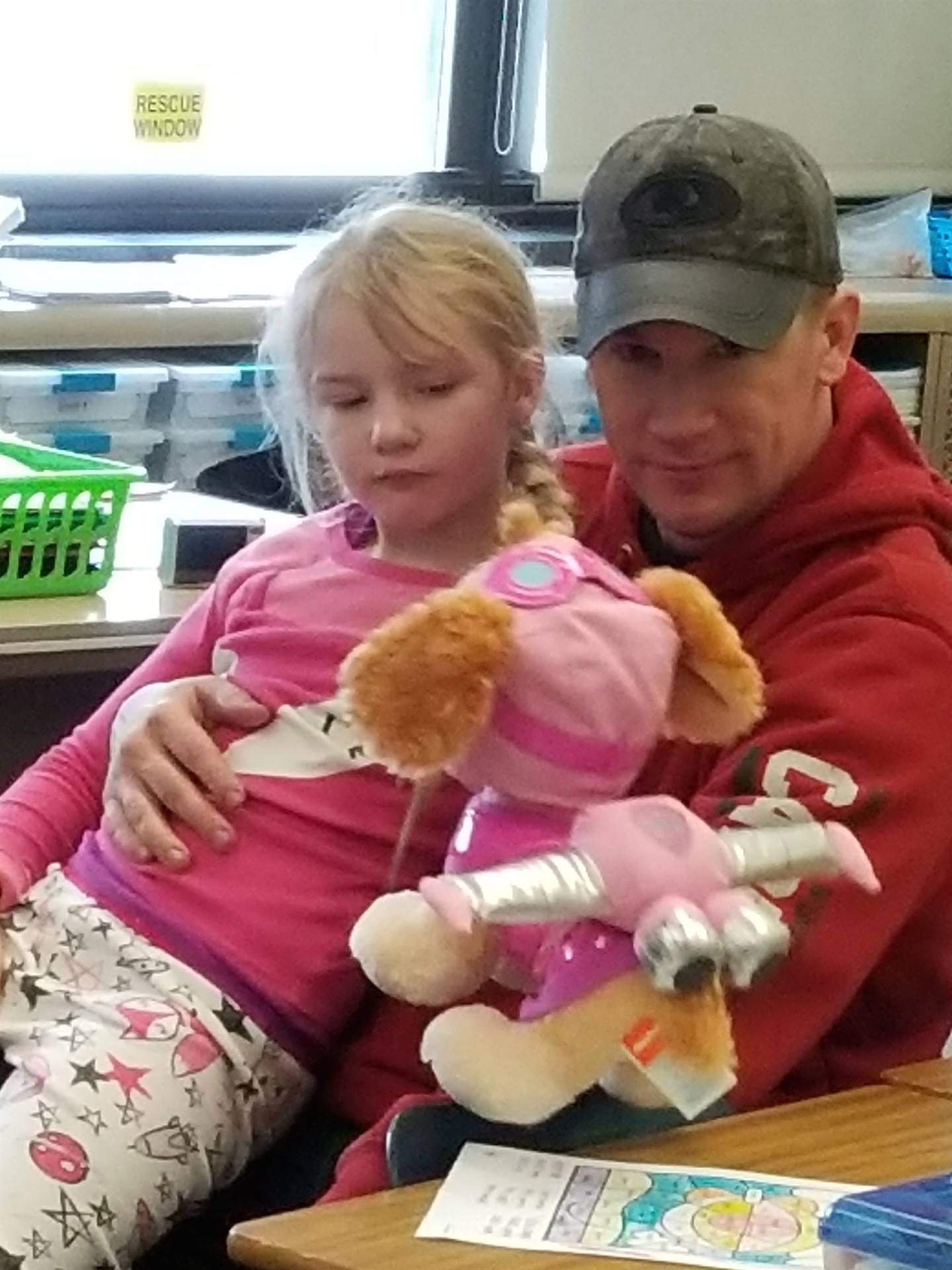 Child and father at first grade read-in