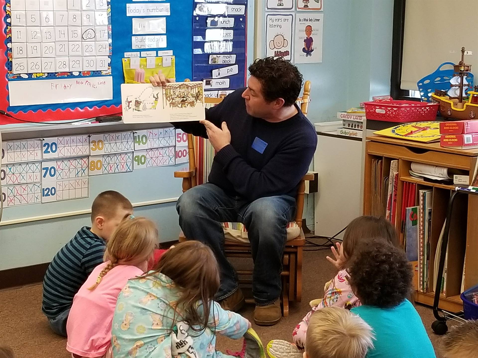 Father reads to children.
