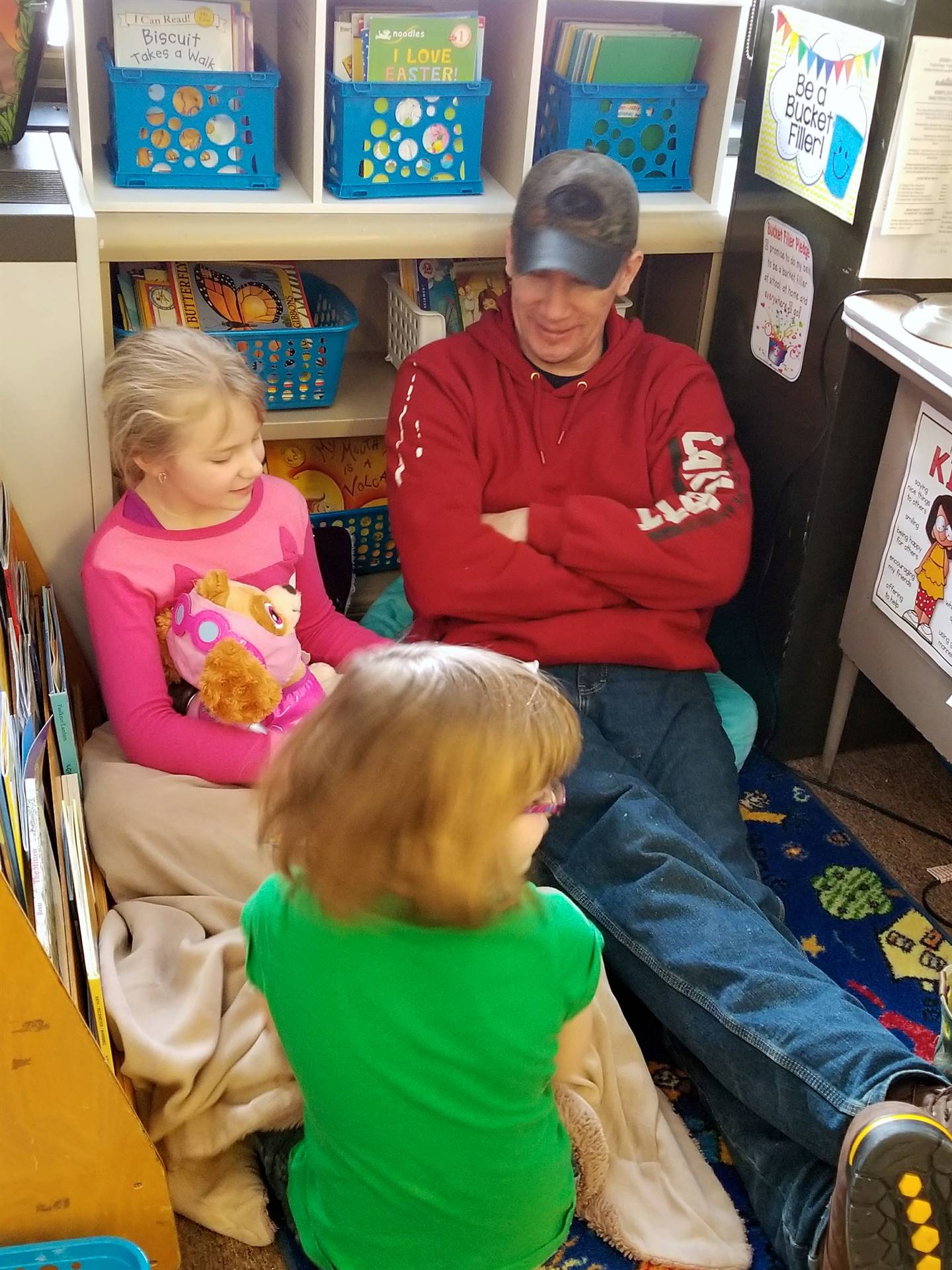 Father listens to students read.