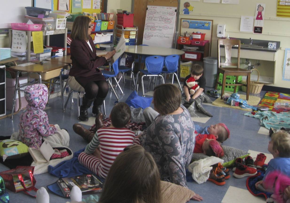 Principal reads to students for read across America celebration.