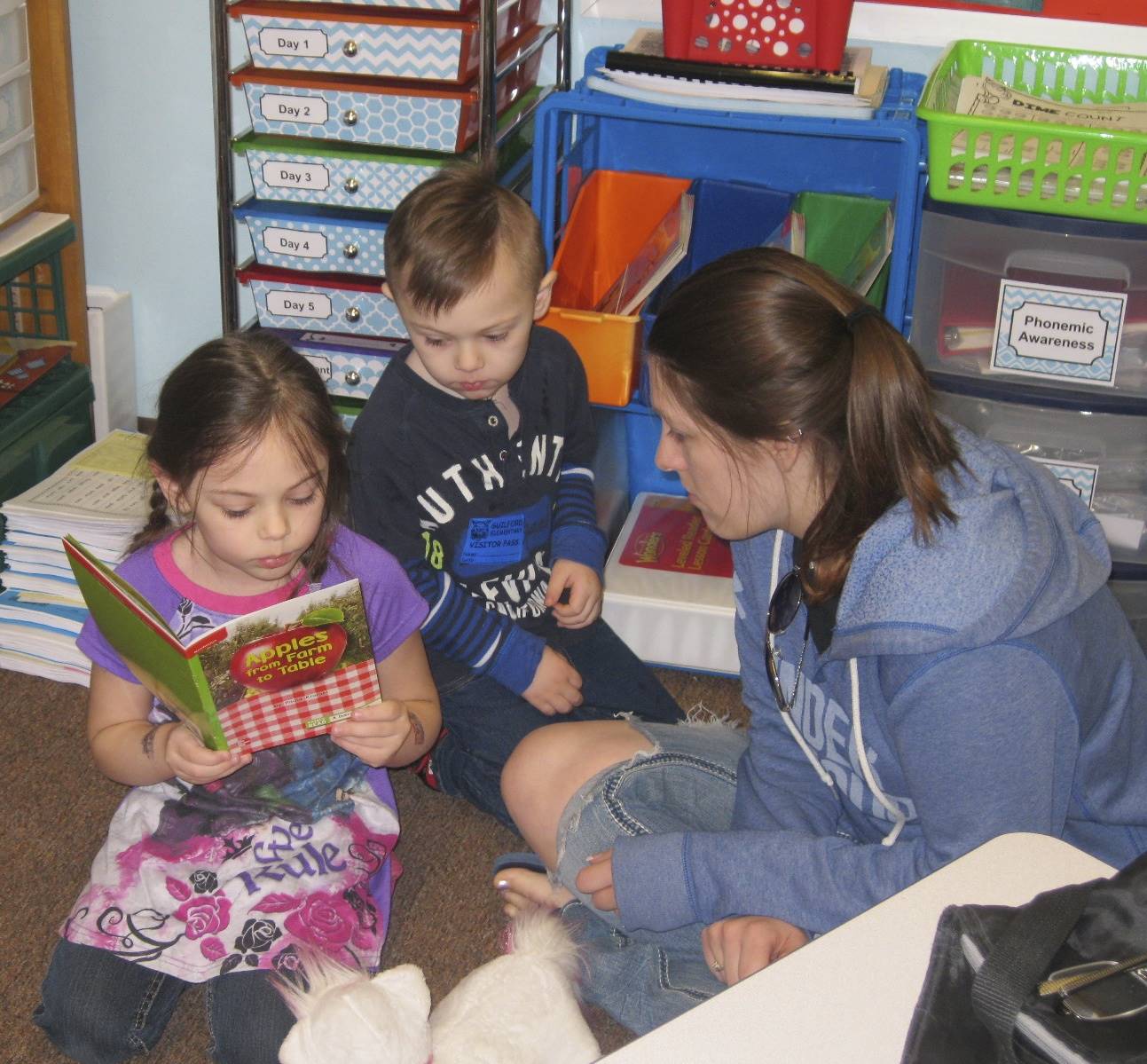 Parent listens to her child read.