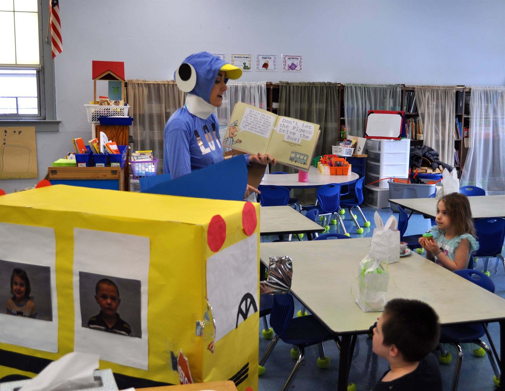 Teacher dressed up like a pigeon reading to students.