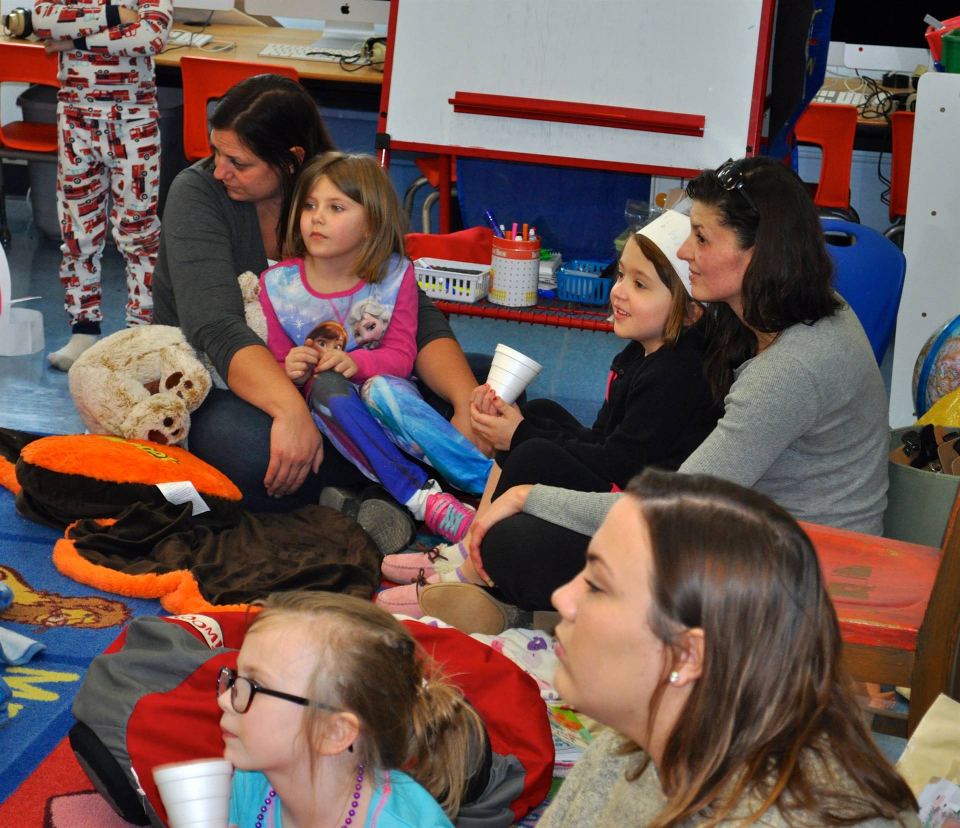 Parents and students listening to a story.